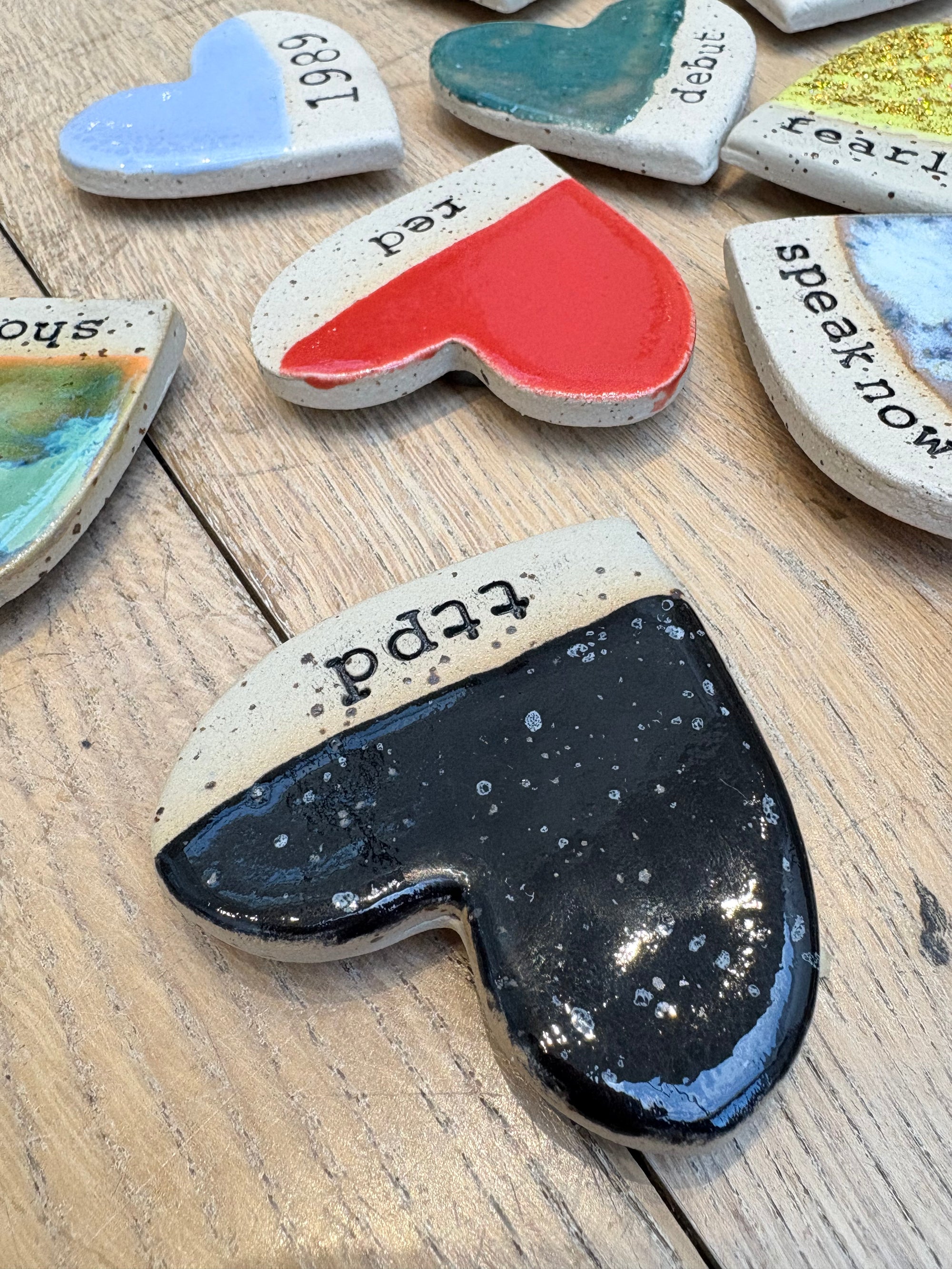 Twelve heart shaped Taylor Swift album magnets