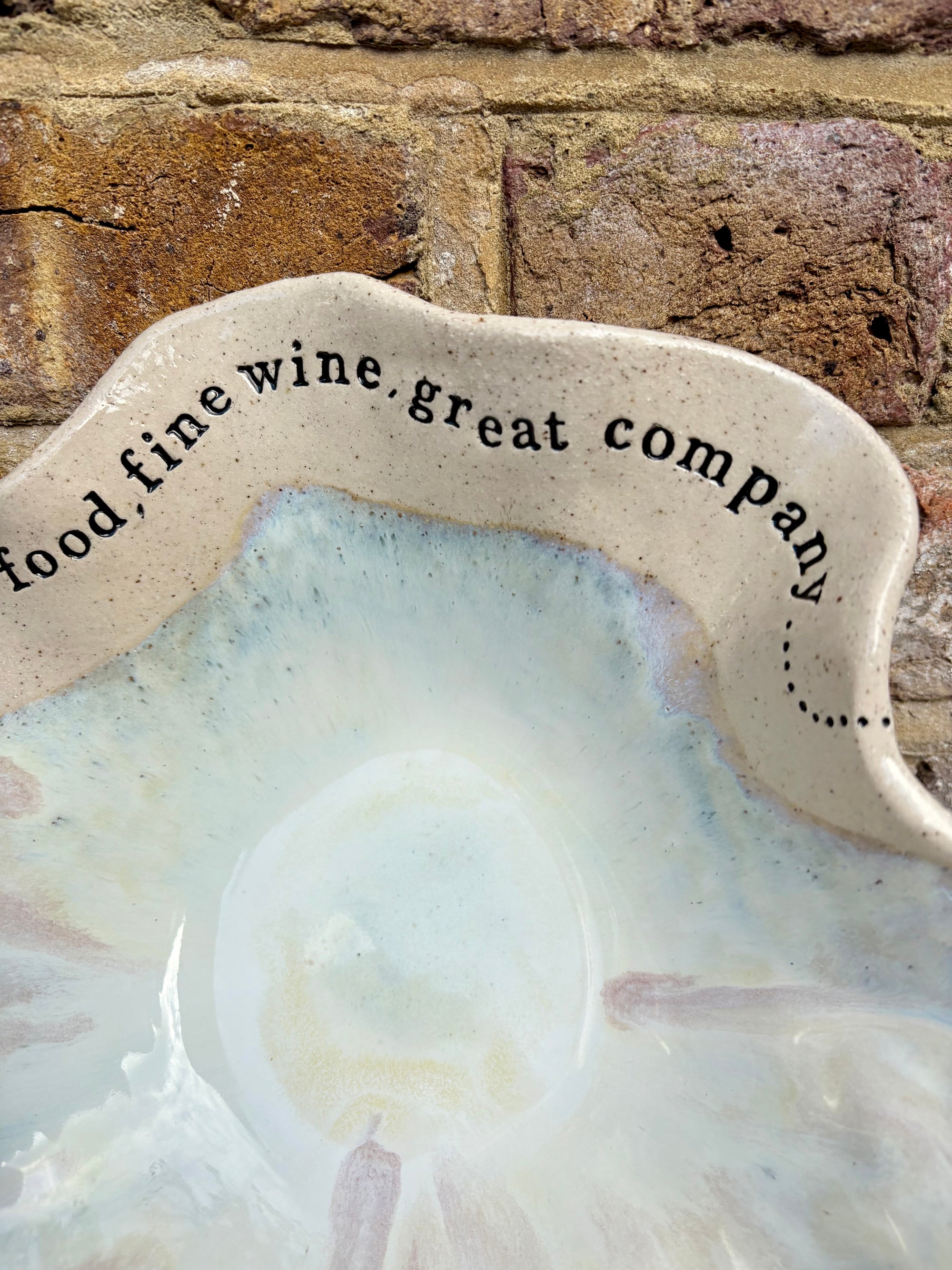 "good food, fine wine, great company..." serving dish