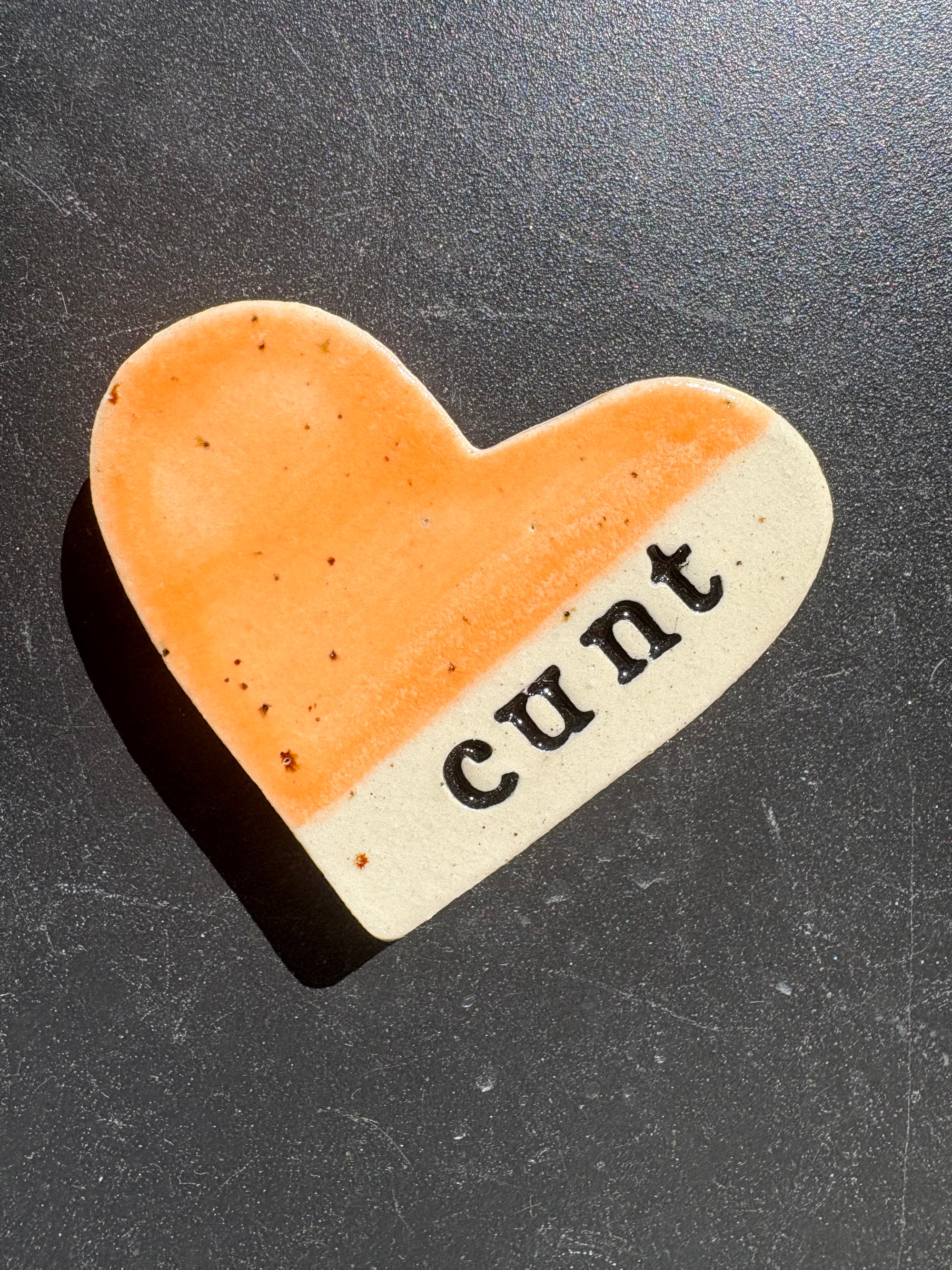 “cunt" magnet (orange, medium)