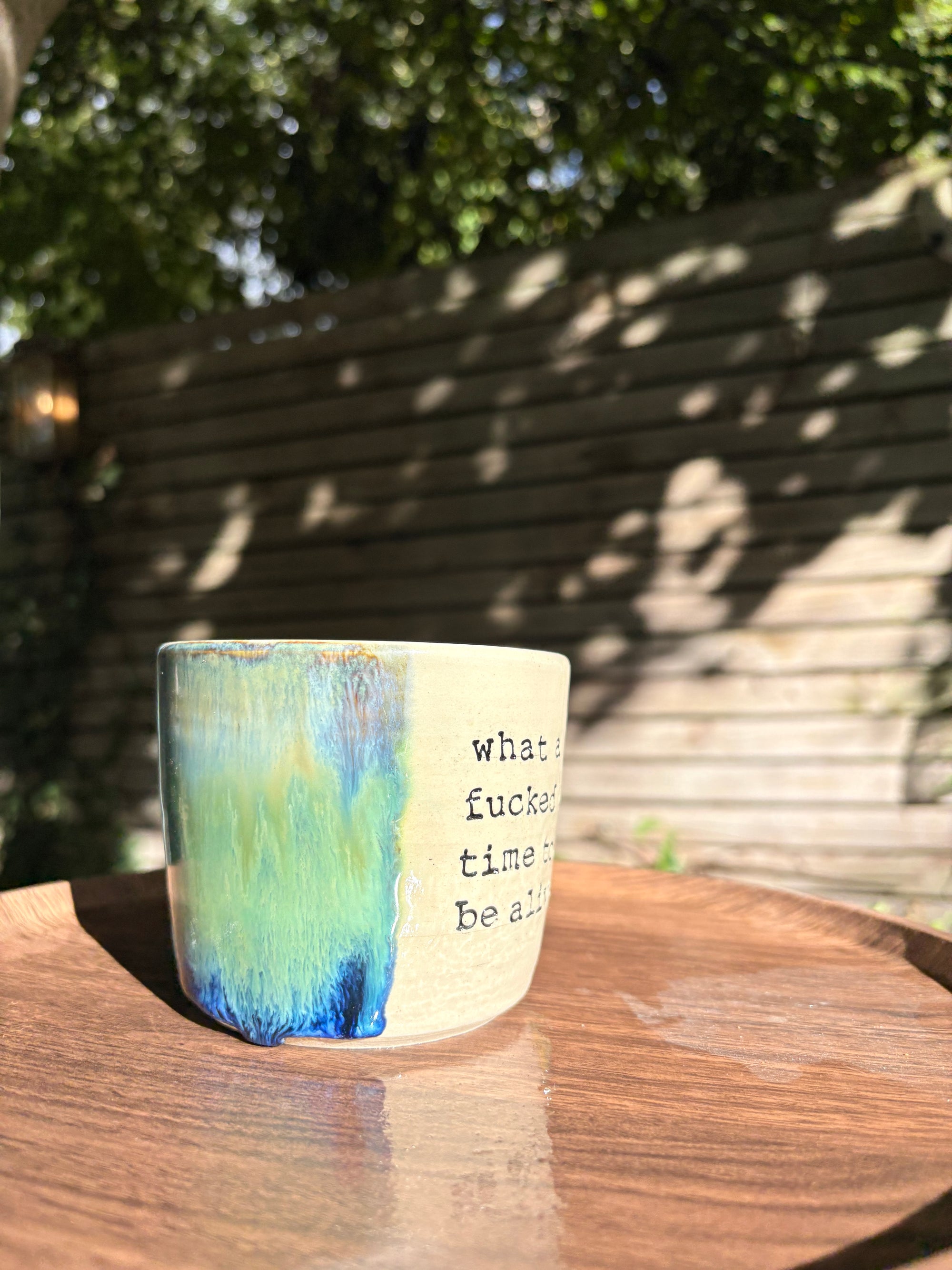 "what a fucked up time to be alive" mug (green/blue)