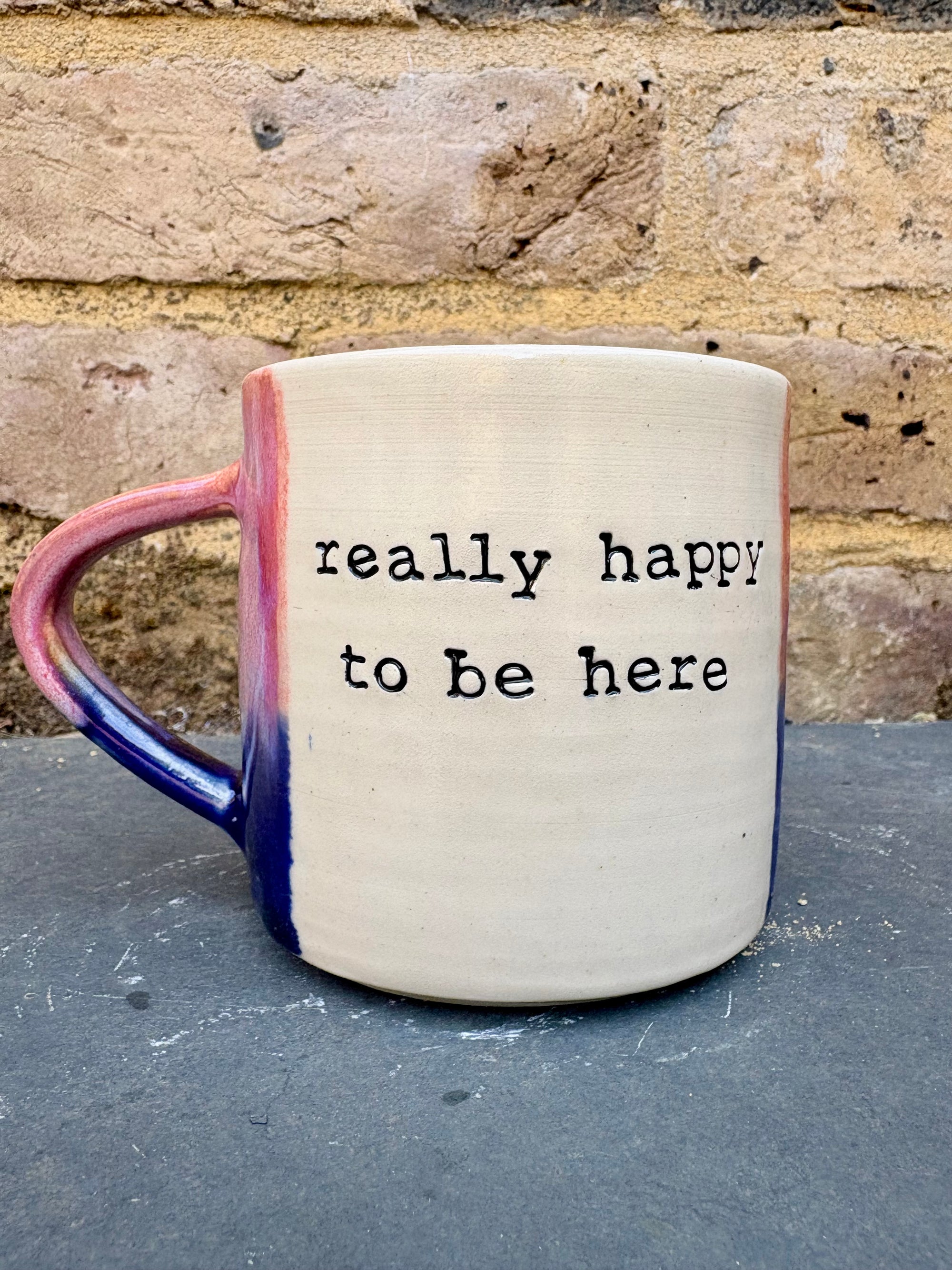 "really happy to be here” "what a bunch of cunts" mug (pink/blue)