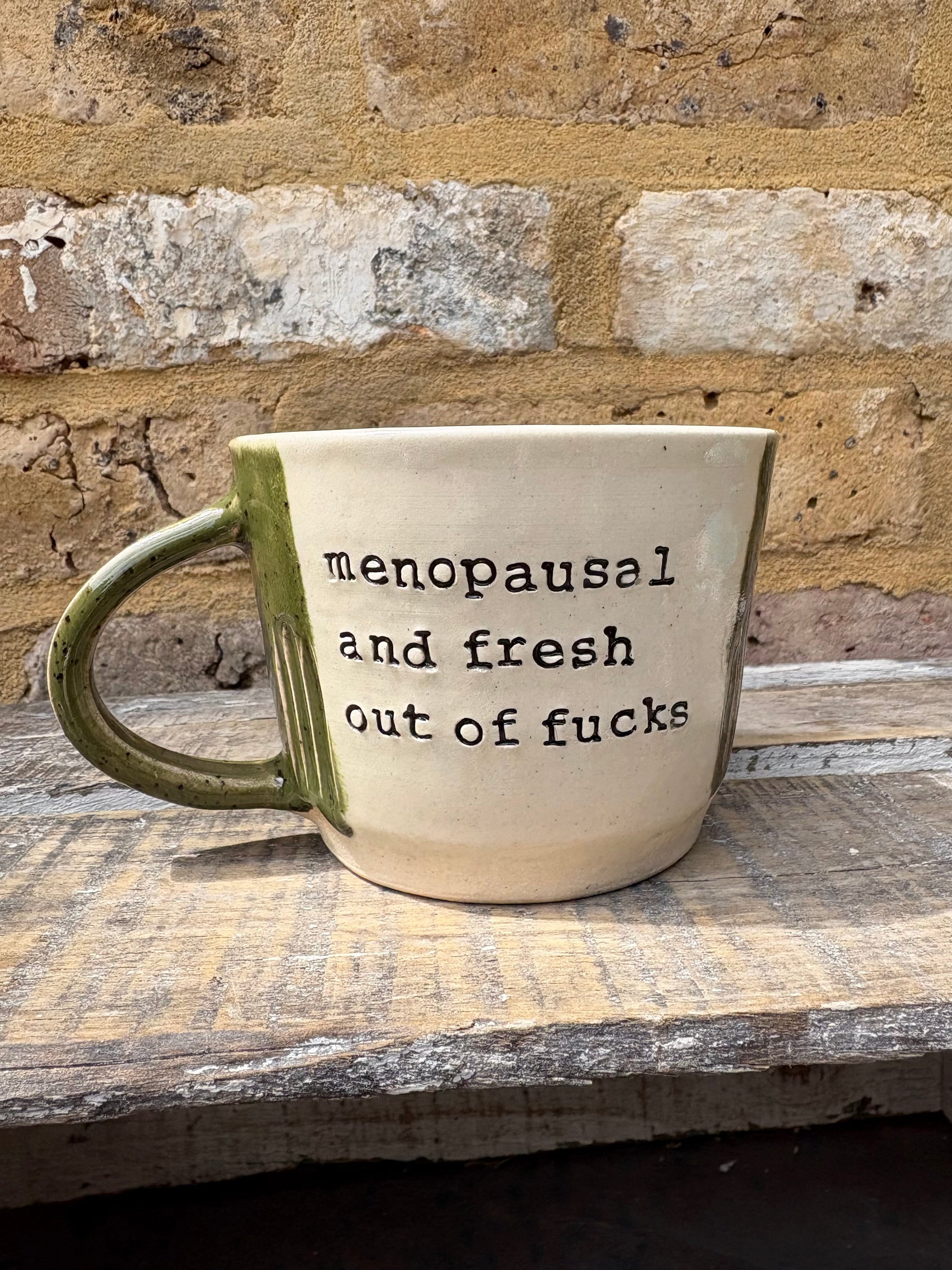 "menopausal and fresh out of fucks" mug (speckled green)