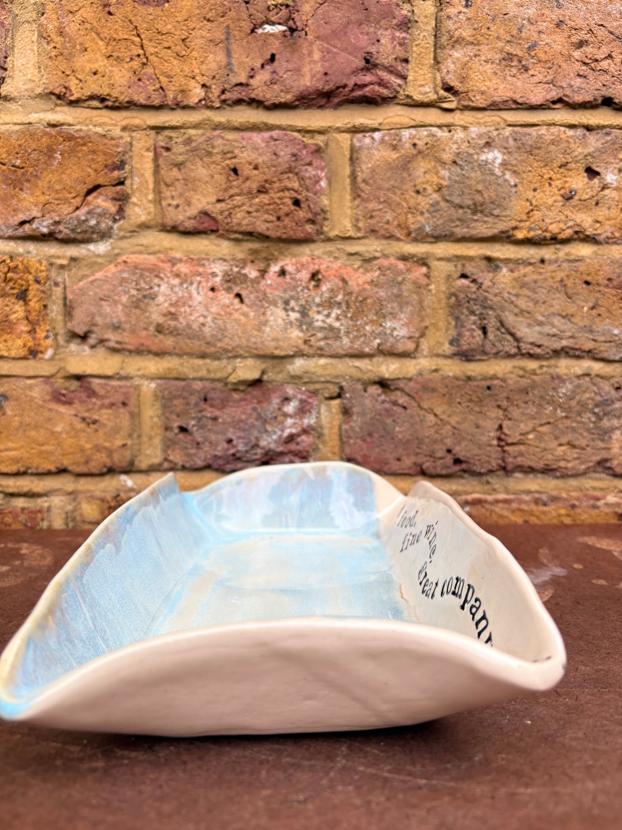 “good food, fine wine, great company..." rectangular salad/serving dish