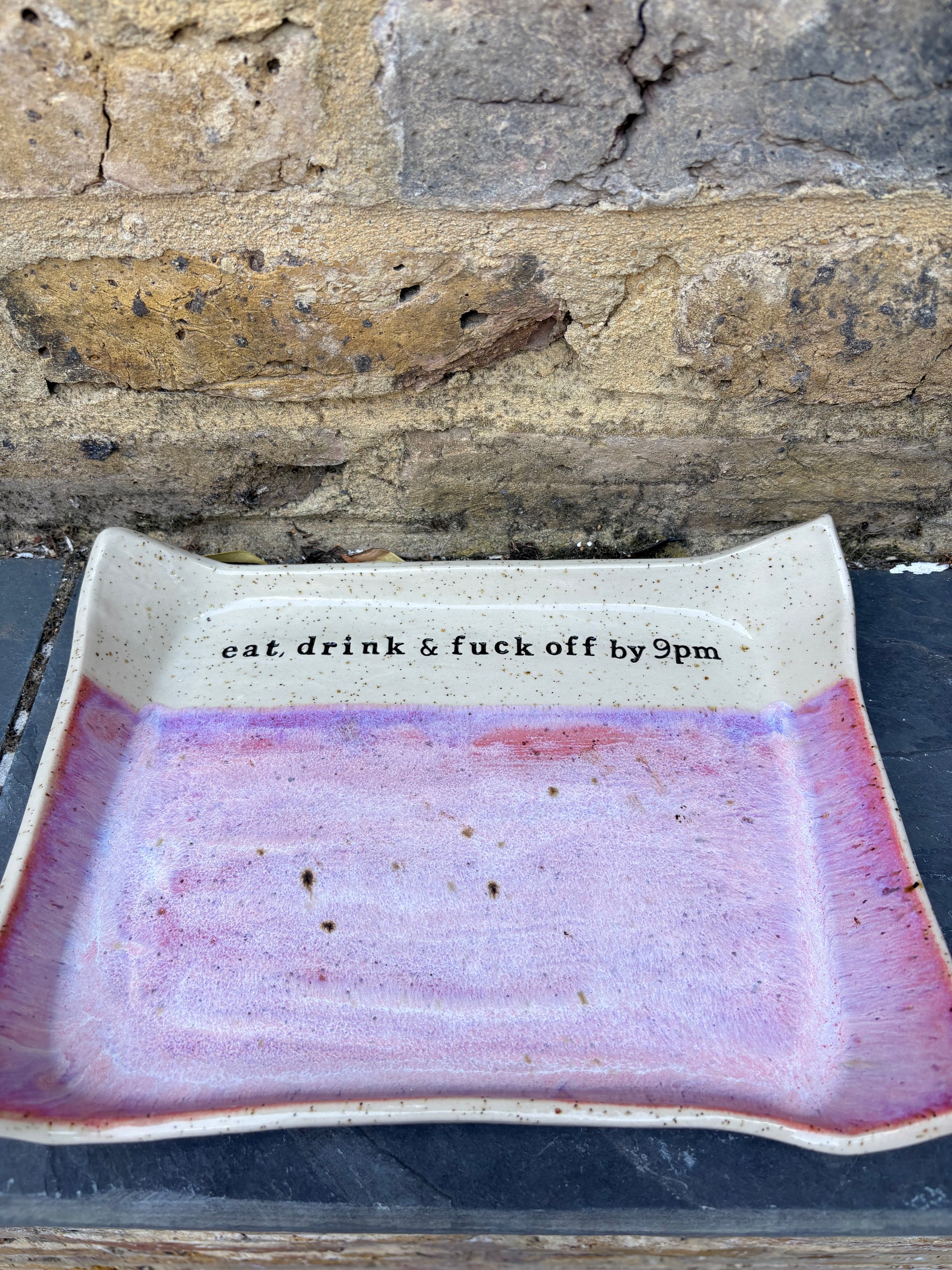 “eat, drink and fuck off by 9pm" rectangular dish (pink, flecked clay)