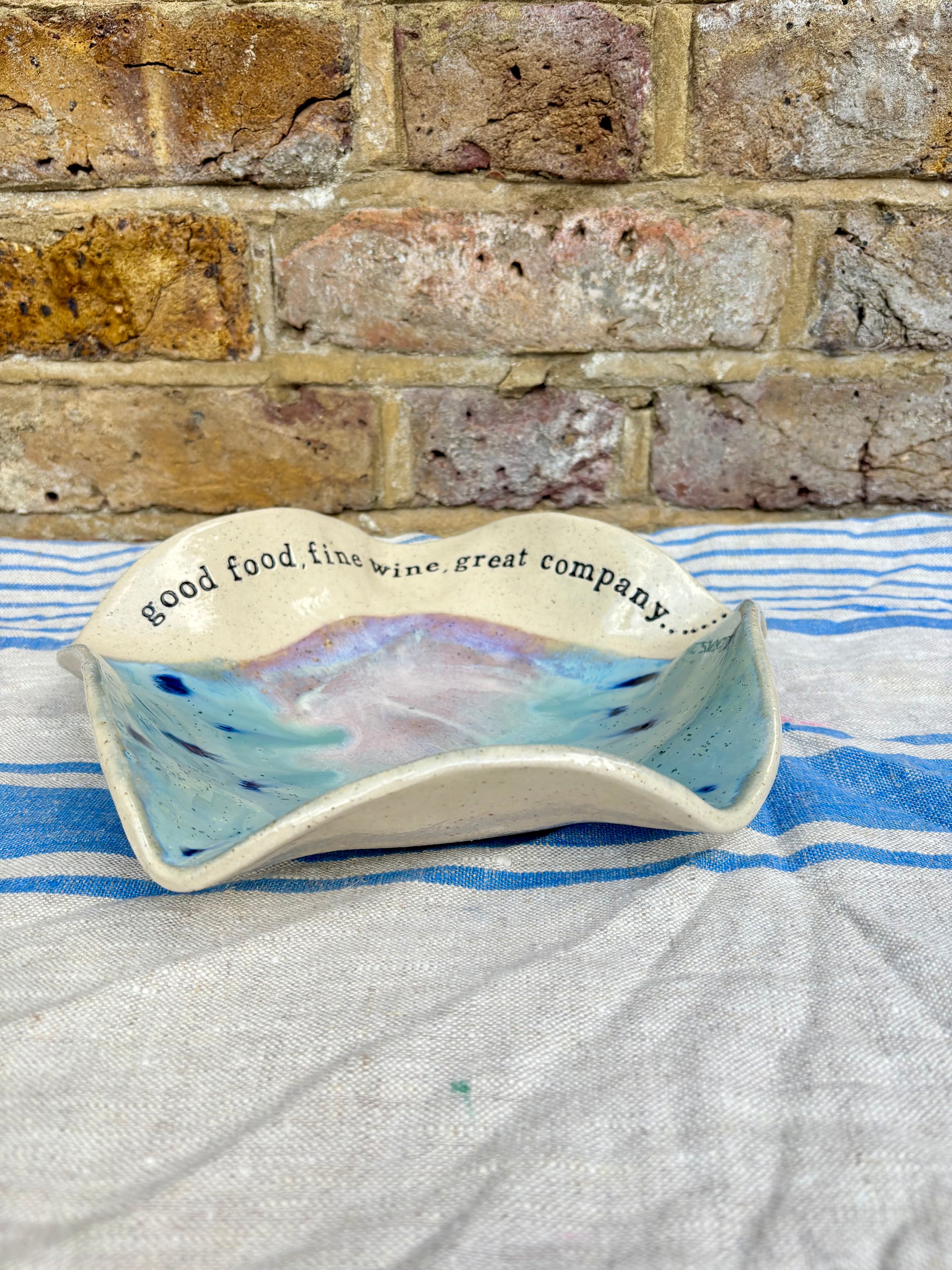 "good food, fine wine, great company..." serving dish