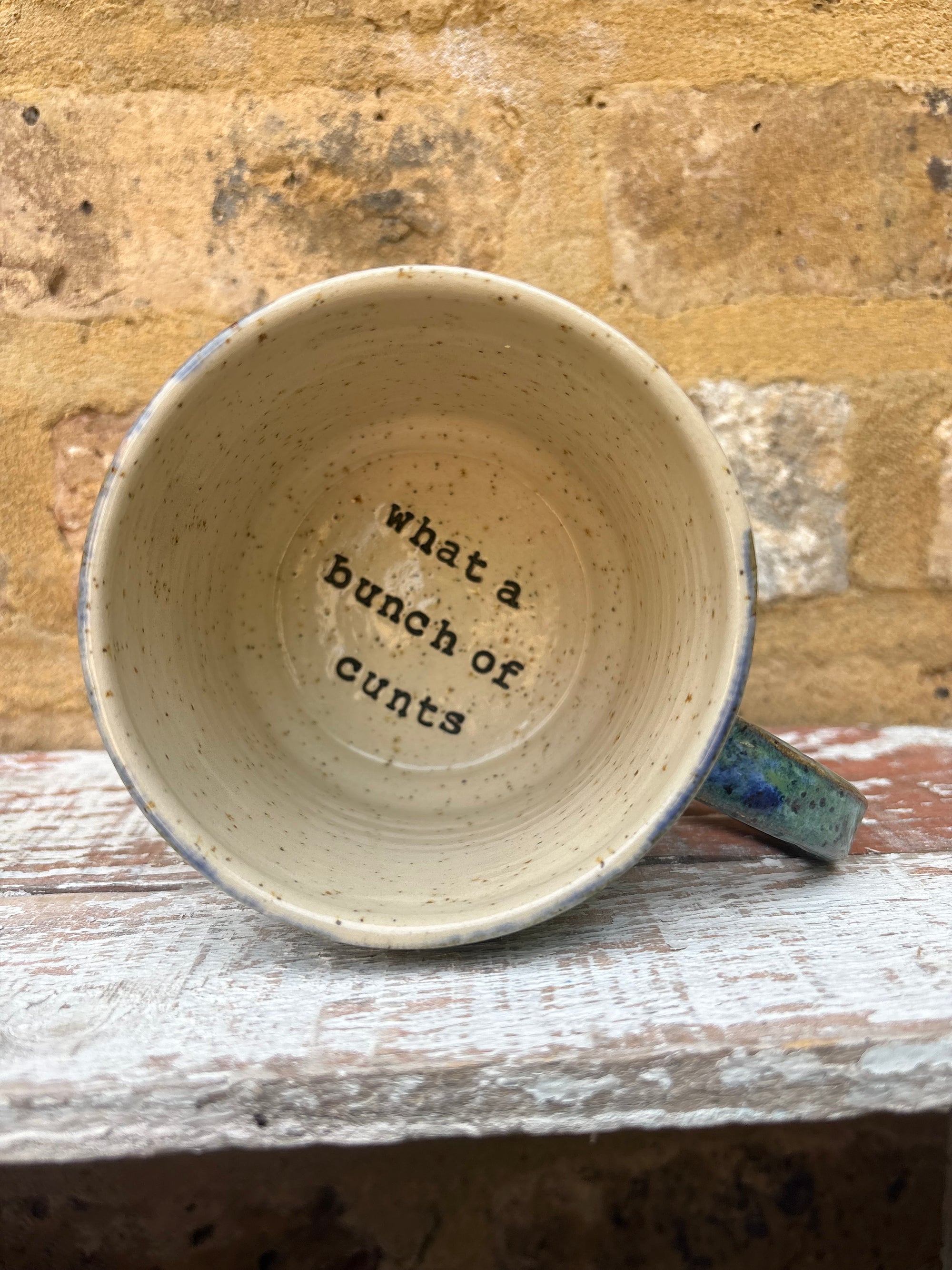 "really happy to be here” "what a bunch of cunts" mug (blue/green)
