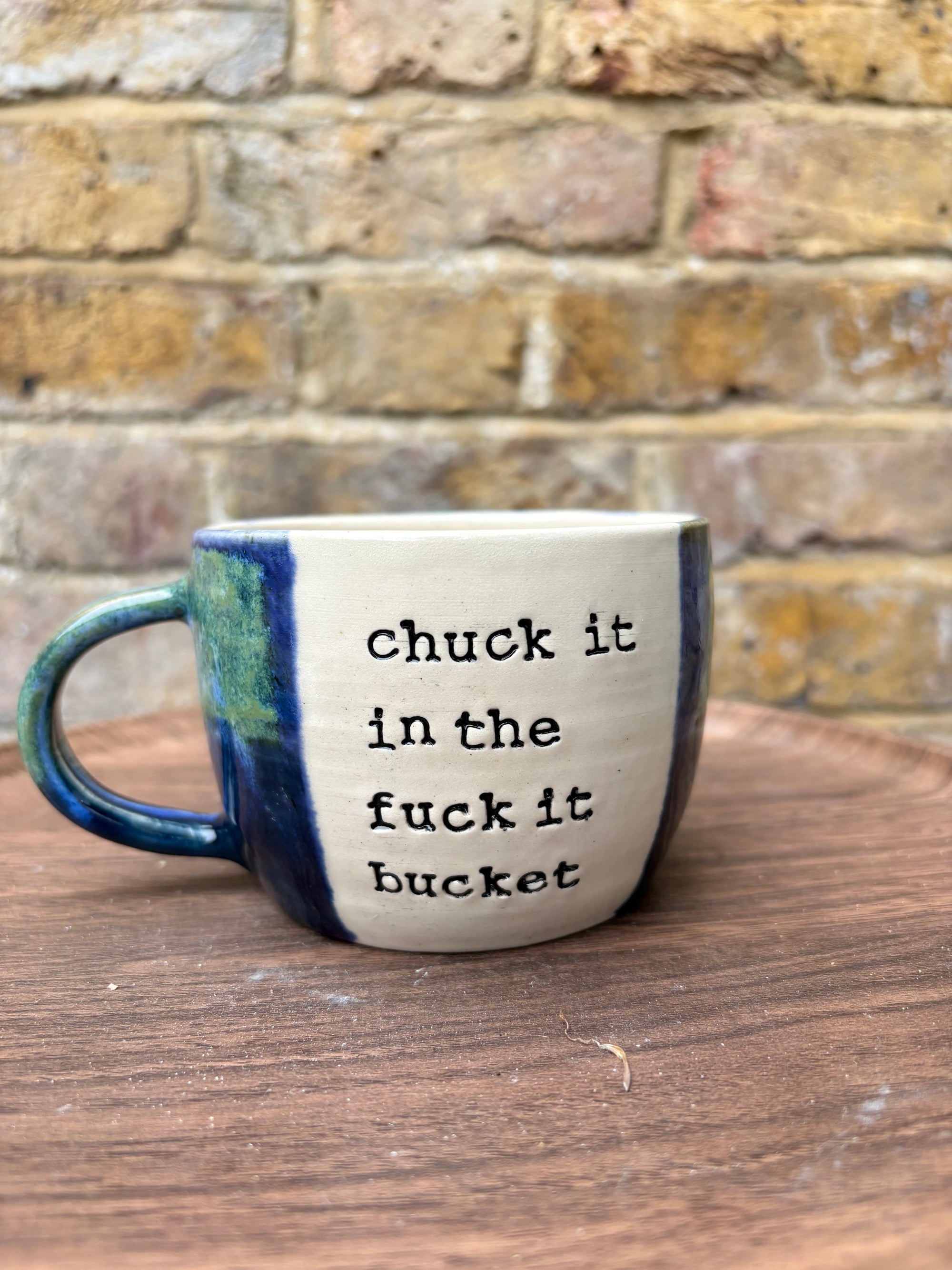 “chuck it in the fuck it bucket" mug (blues/ greens)