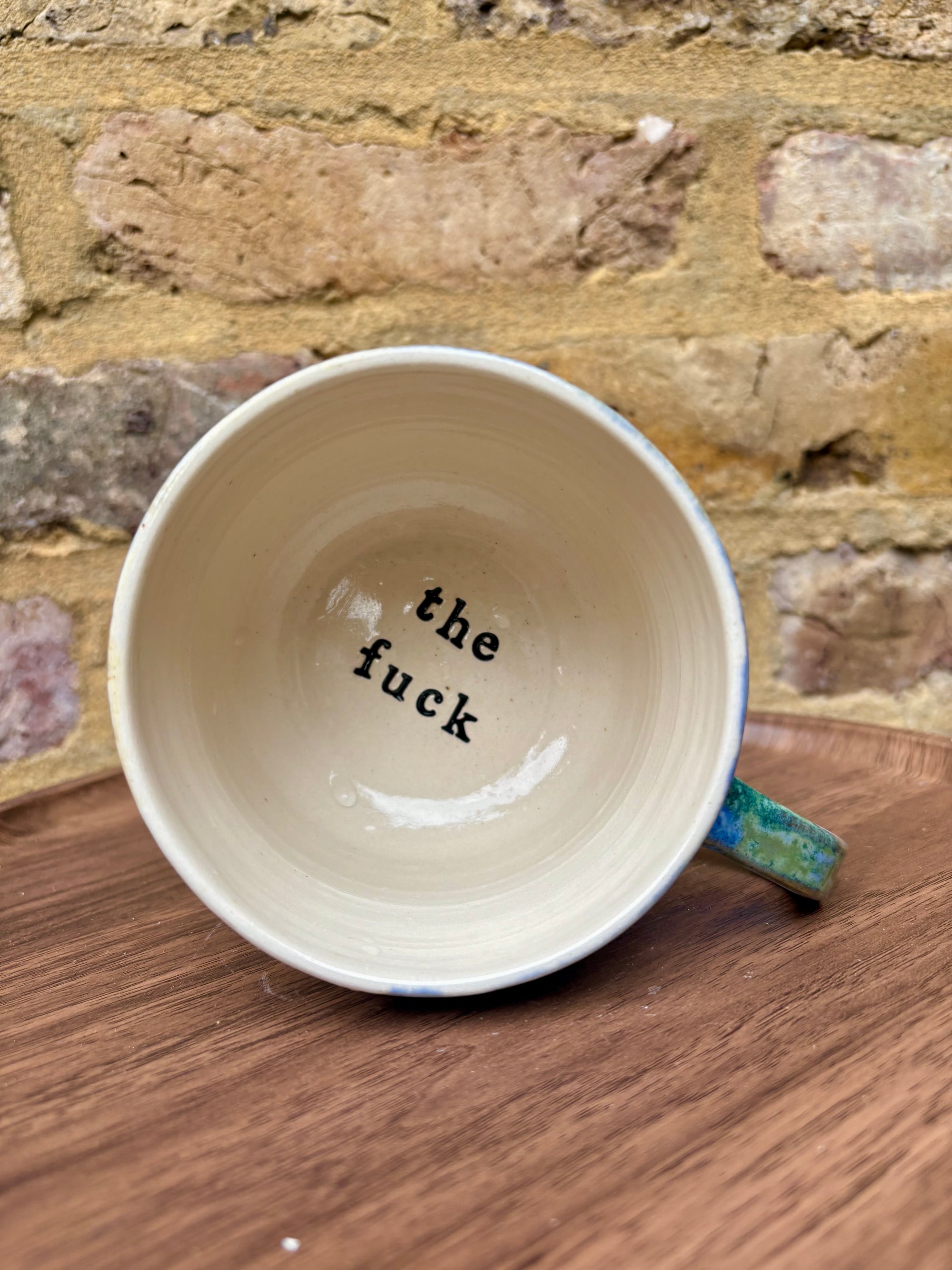 “What” “the fuck” mug (cream, blue/green)