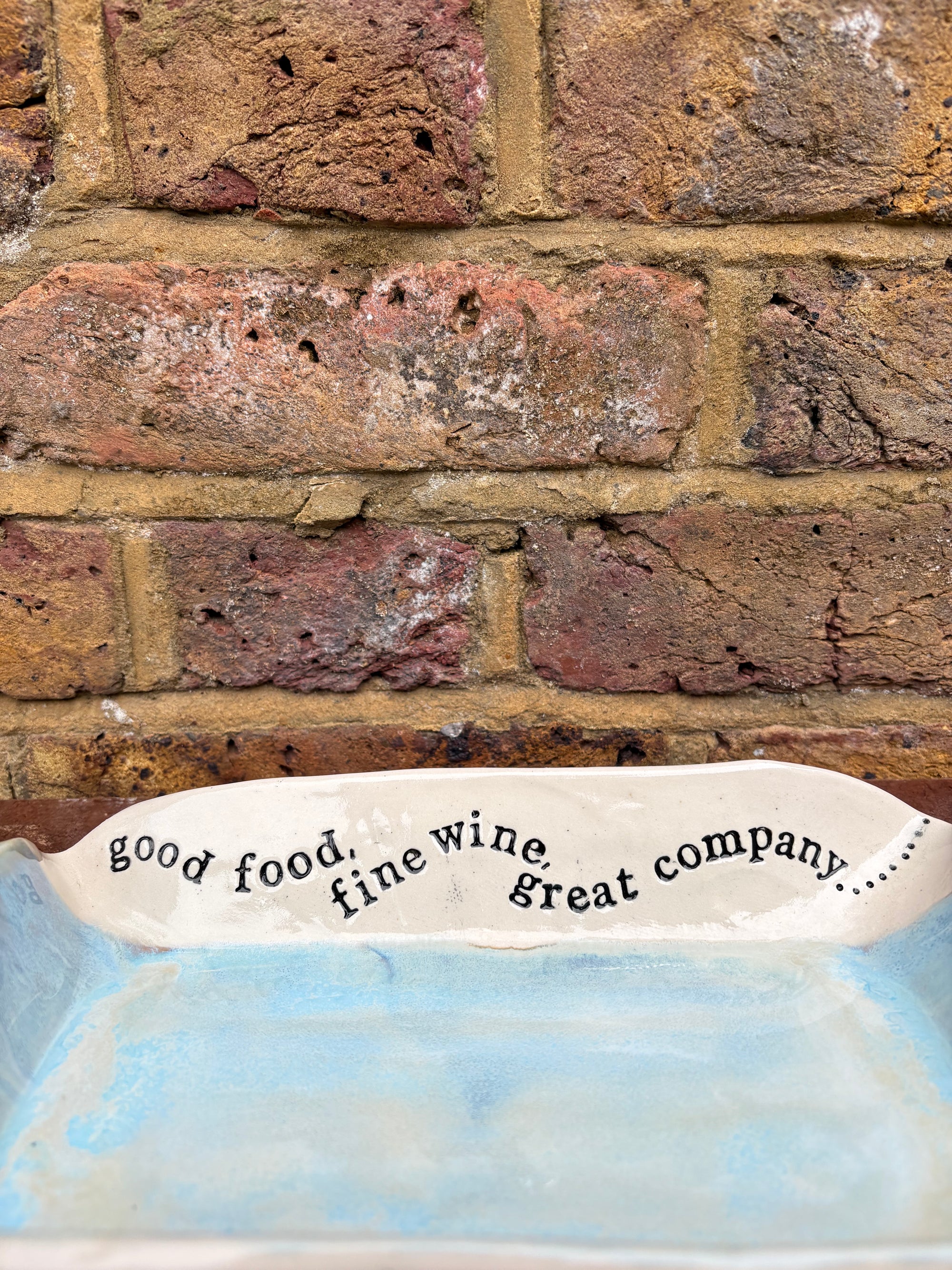 “good food, fine wine, great company..." rectangular salad/serving dish