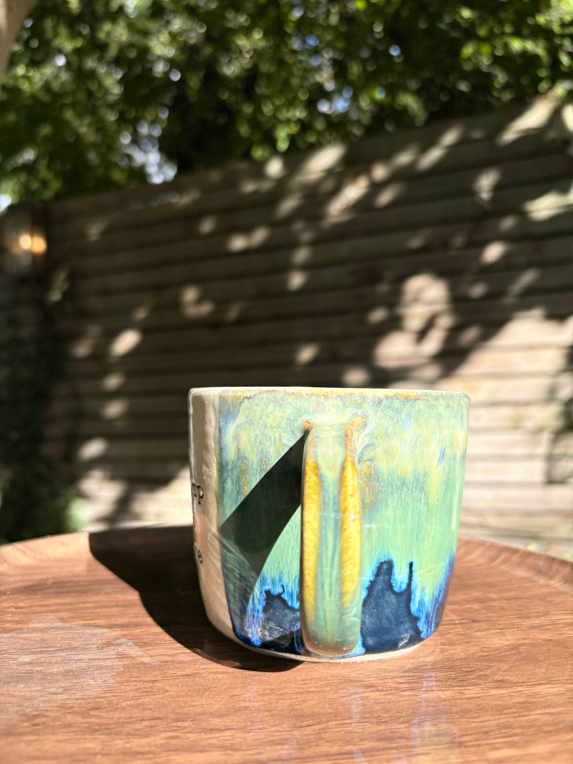 "what a fucked up time to be alive" mug (green/blue)