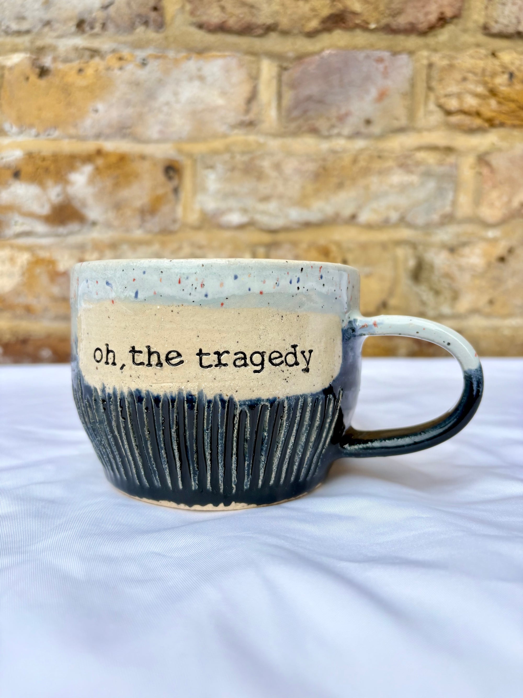 "oh the tragedy" mug