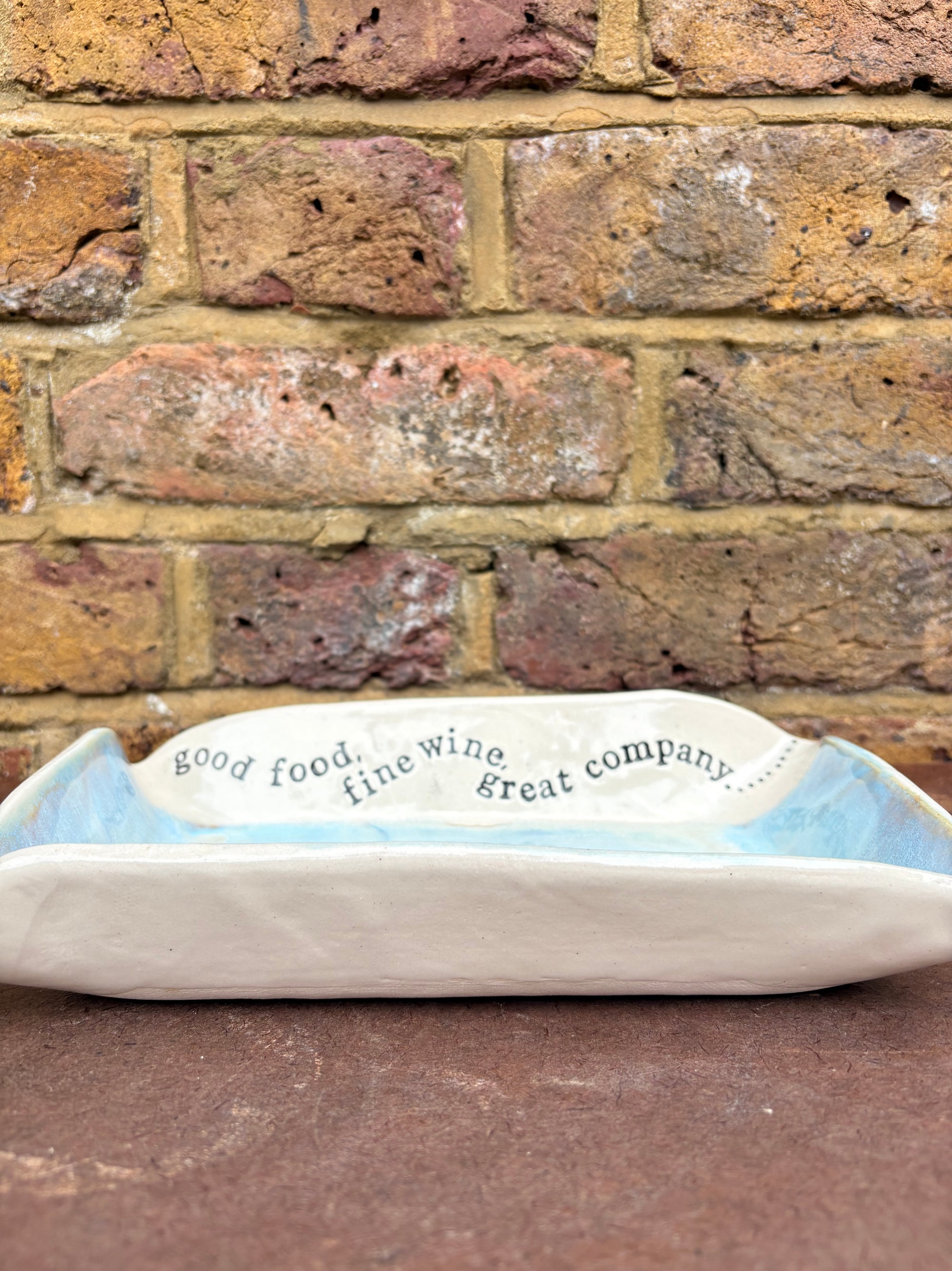 “good food, fine wine, great company..." rectangular salad/serving dish