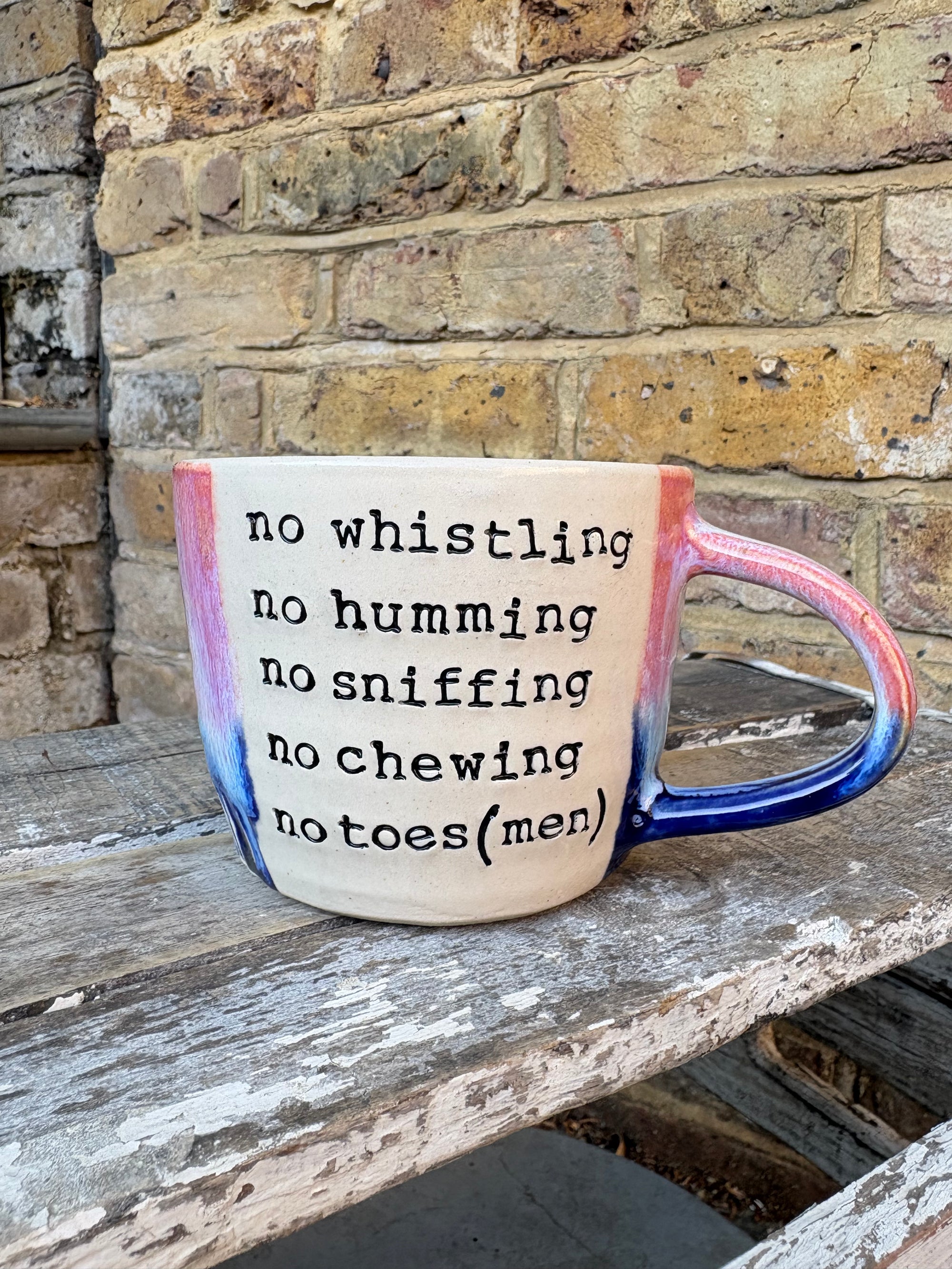 "office rules” "no whistling no humming no sniffing no chewing no toes (men)" mug (pink/blue, 300ml)