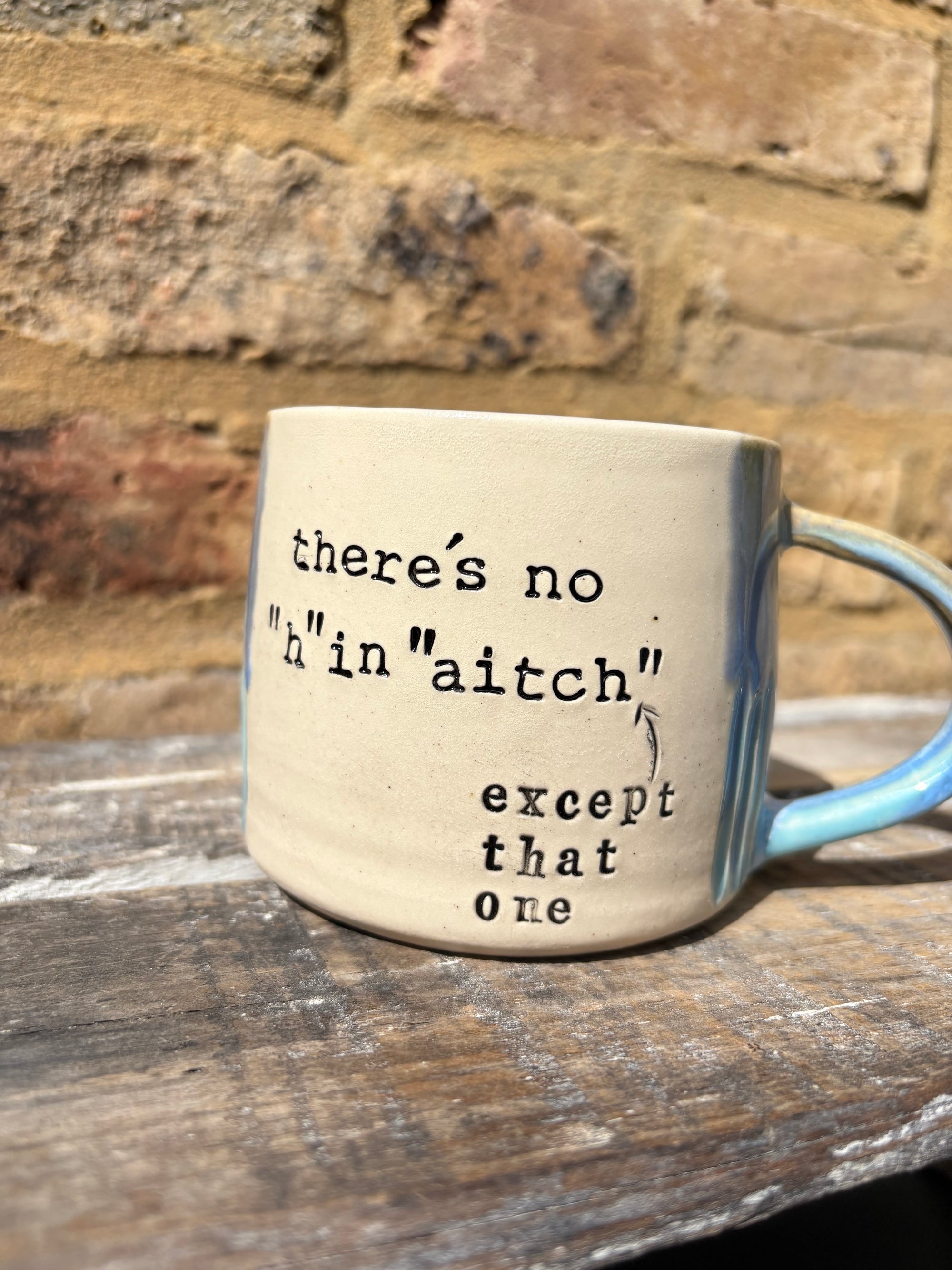 ""there's no "h" in "aitch" except that one" mug (blues)