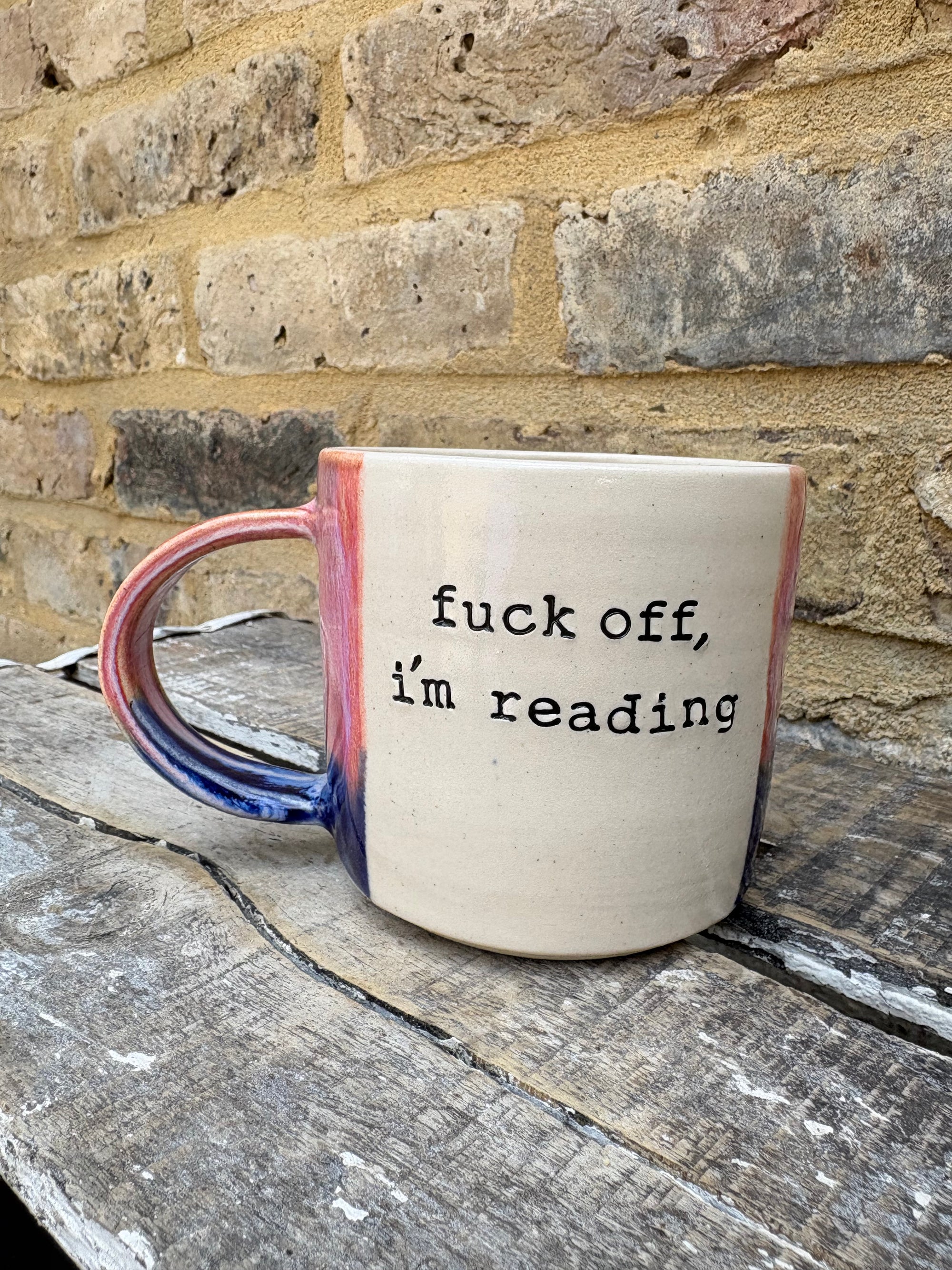 Two “fuck off i’m reading” mugs