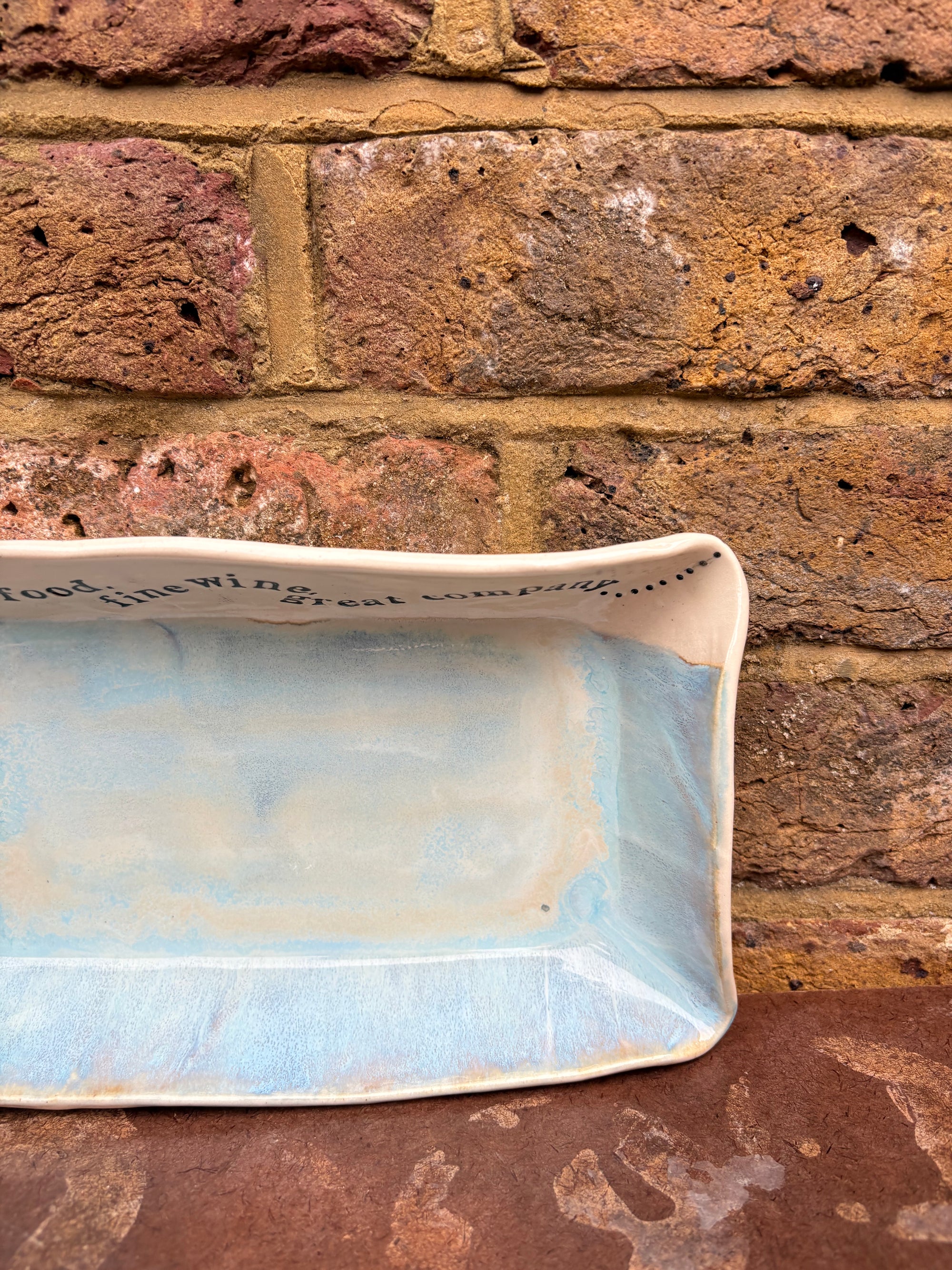 “good food, fine wine, great company..." rectangular salad/serving dish