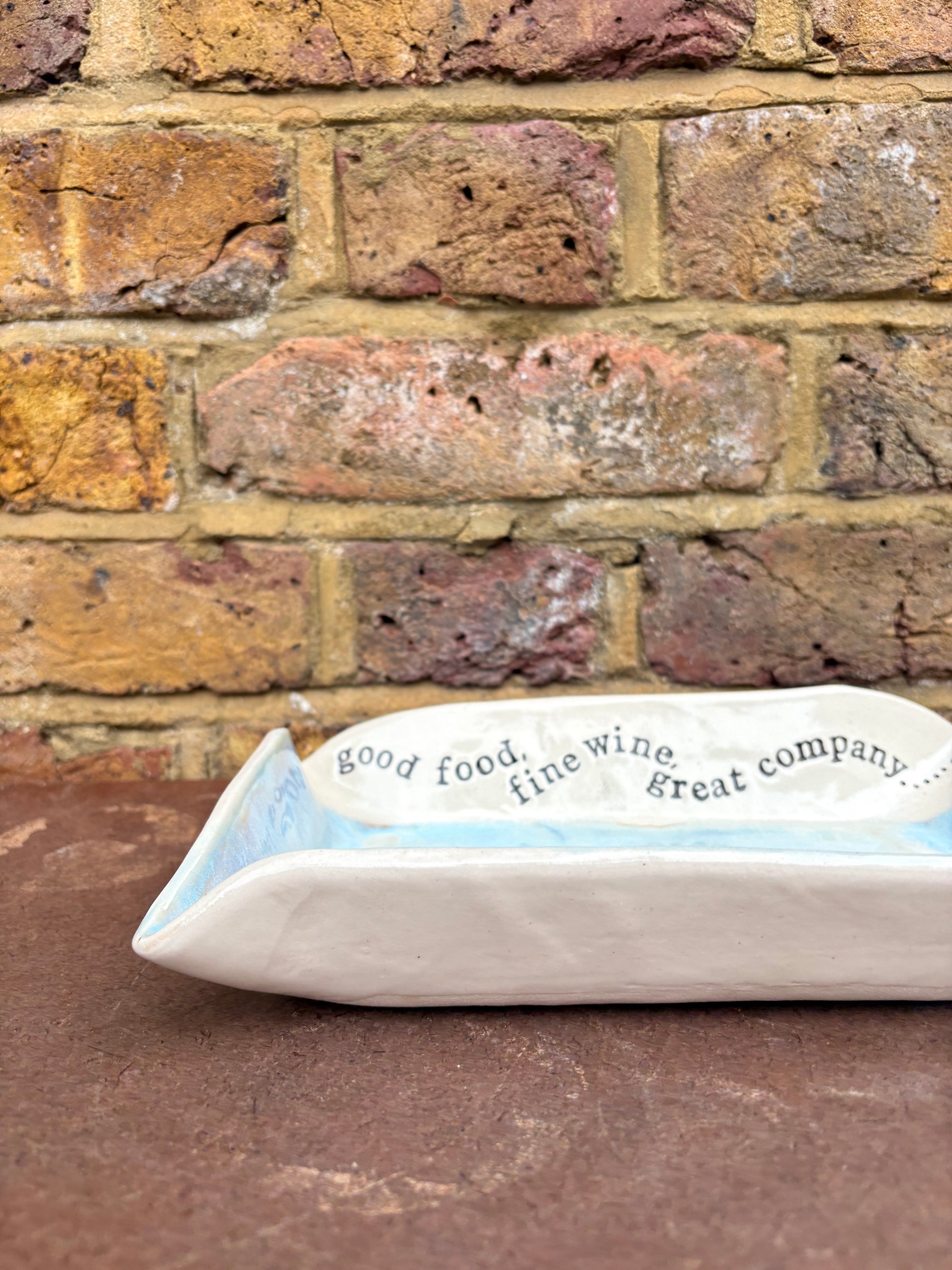 “good food, fine wine, great company..." rectangular salad/serving dish