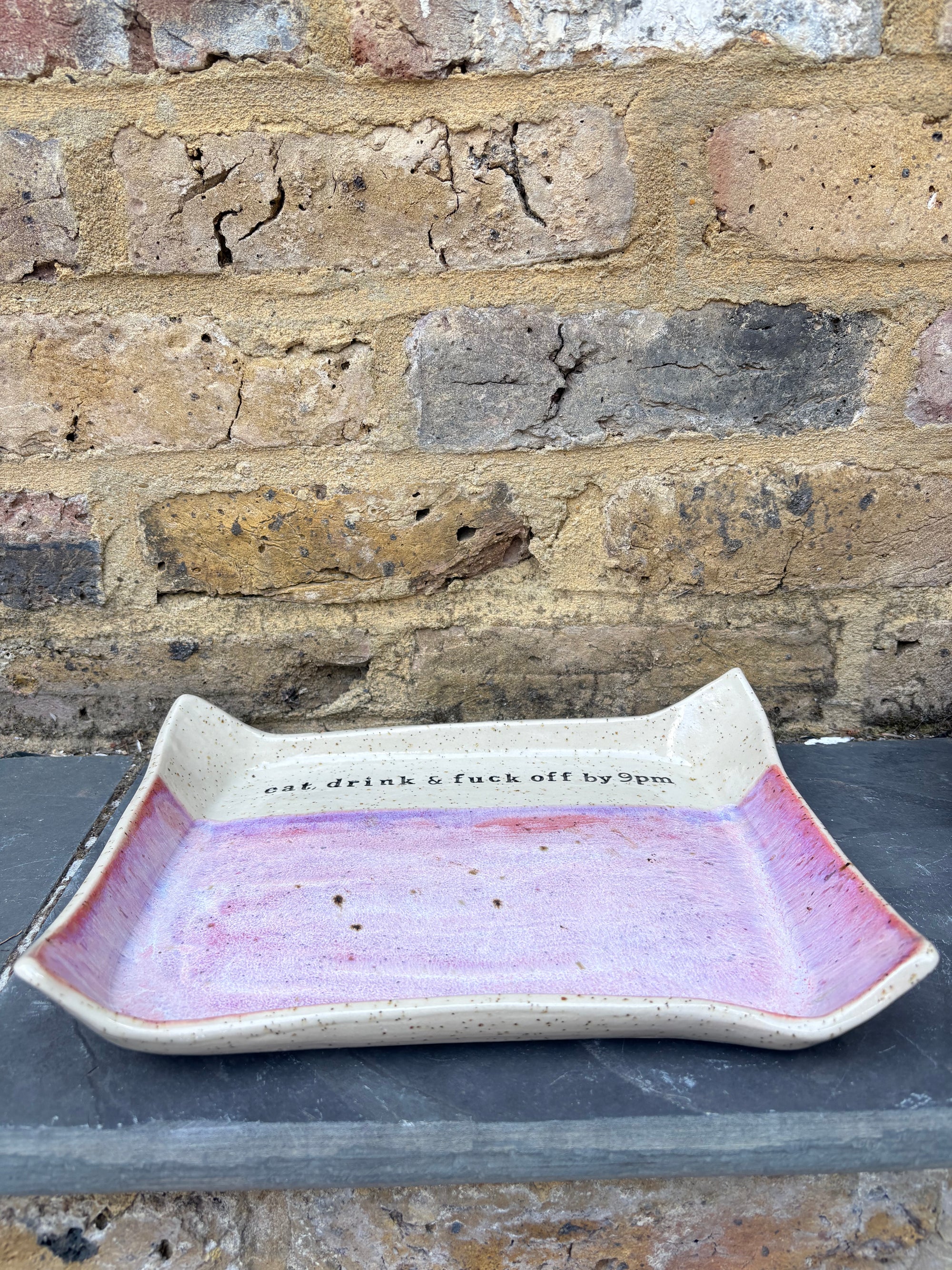 “eat, drink and fuck off by 9pm" rectangular dish (pink, flecked clay)