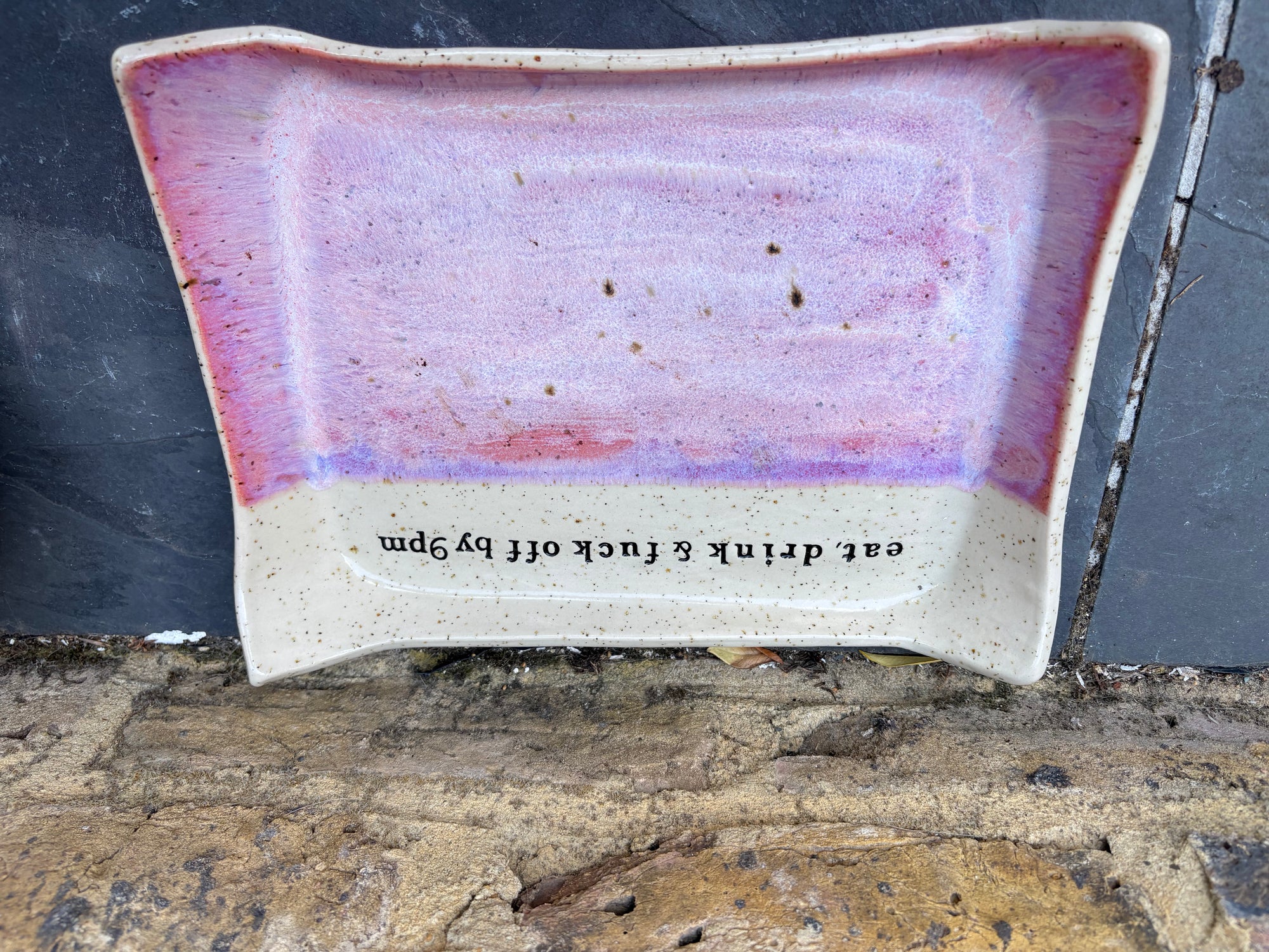 “eat, drink and fuck off by 9pm" rectangular dish (pink, flecked clay)