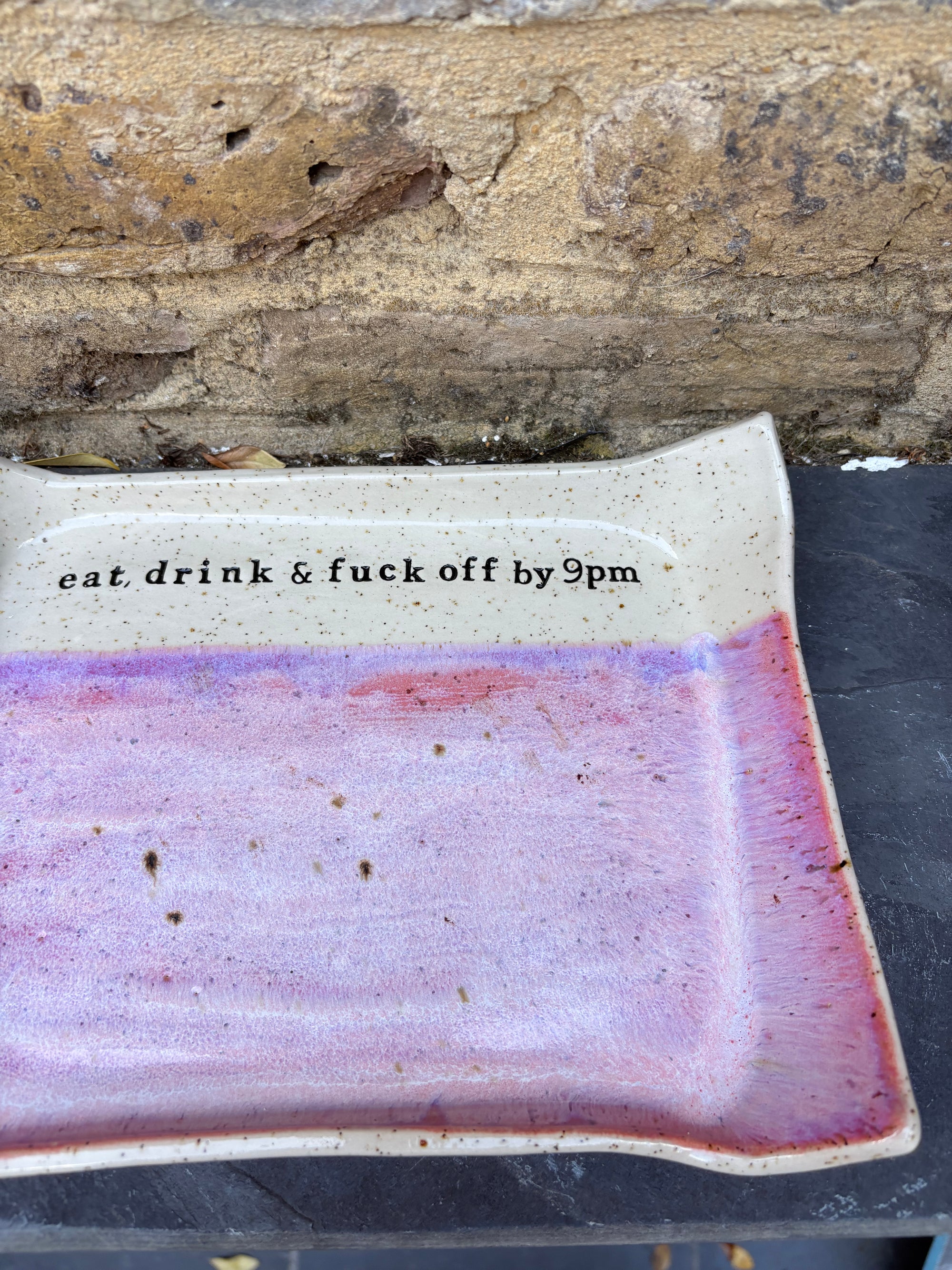 “eat, drink and fuck off by 9pm" rectangular dish (pink, flecked clay)