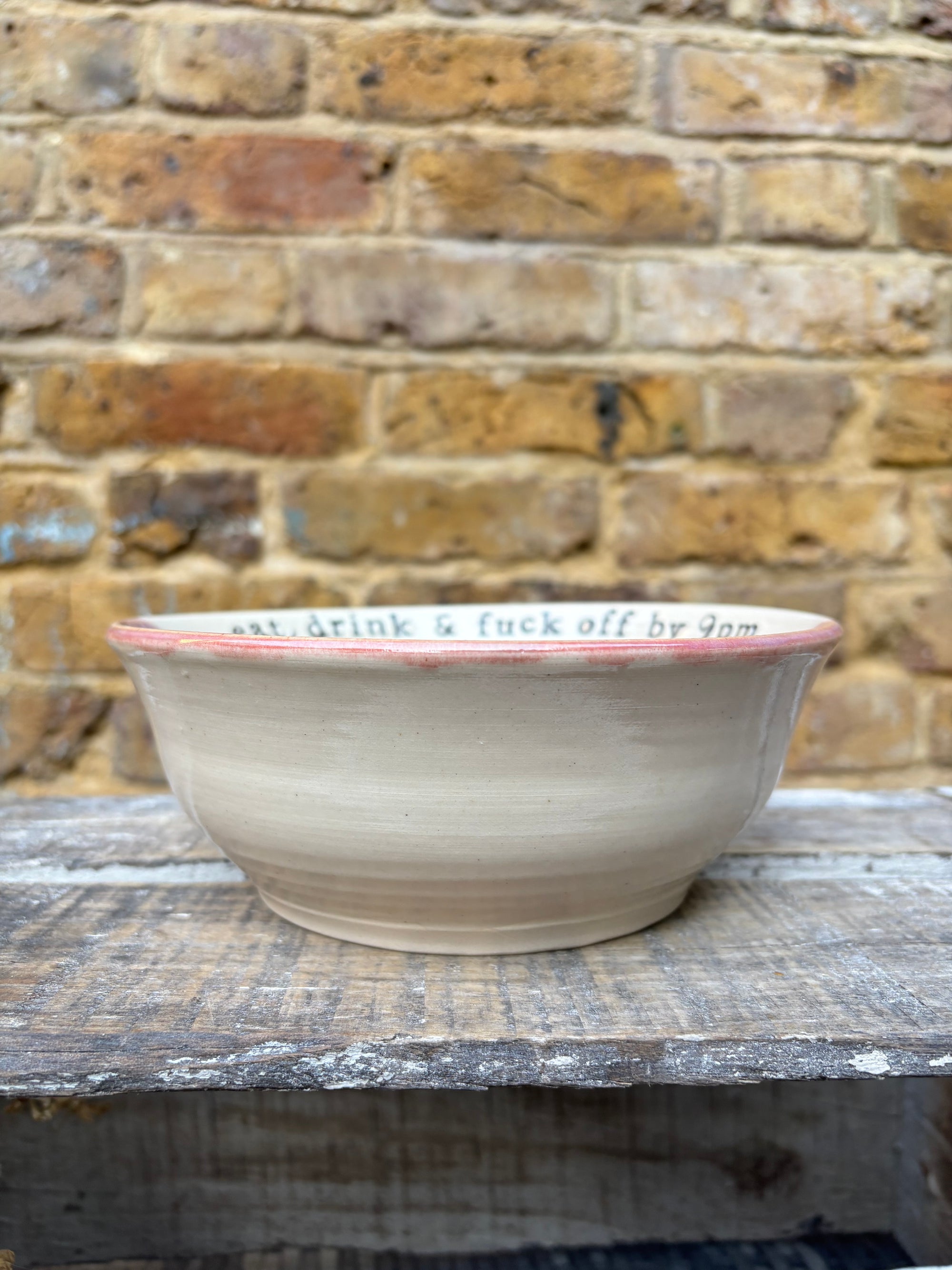 “eat, drink and fuck off by 9pm"  deep round salad/pasta bowl (pink night sky)