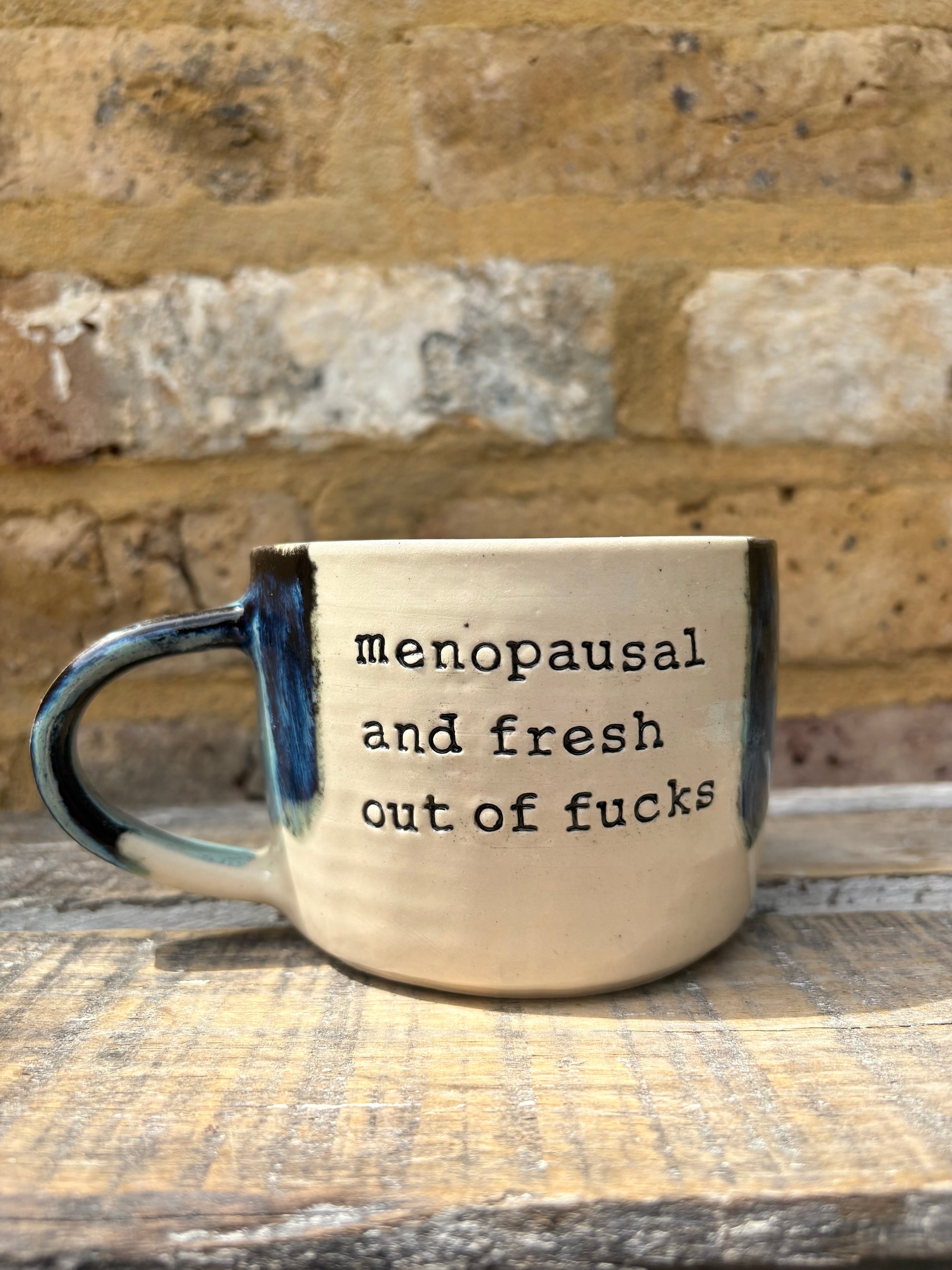 "menopausal and fresh out of fucks" mug (blue shore)
