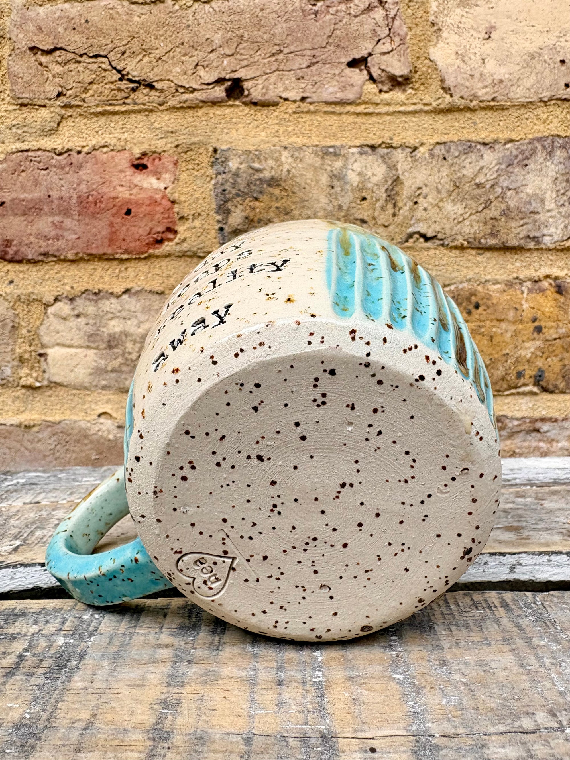“A book a day keeps reality away" mug (turquoise)