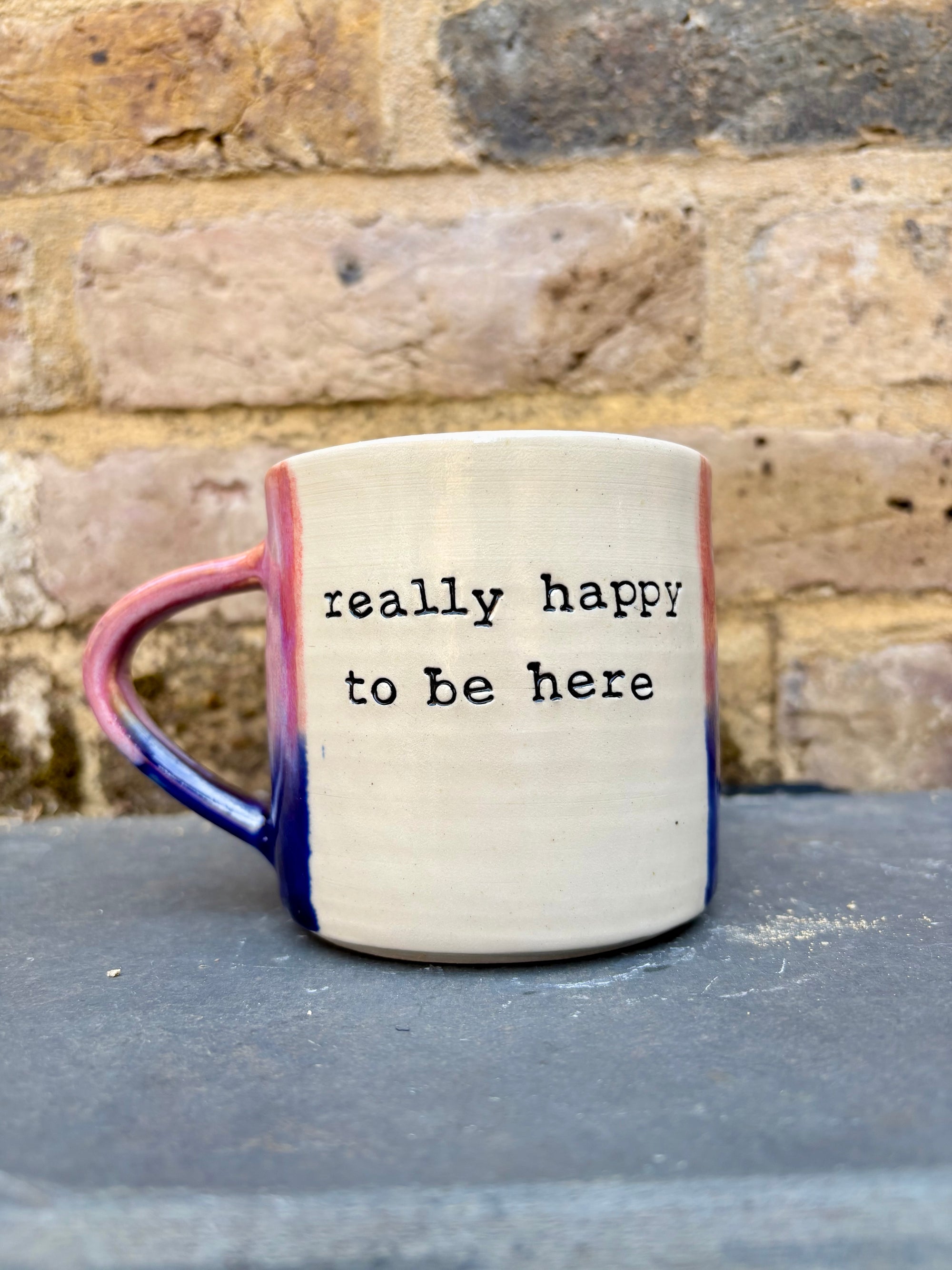 "really happy to be here” "what a bunch of cunts" mug (pink/blue)