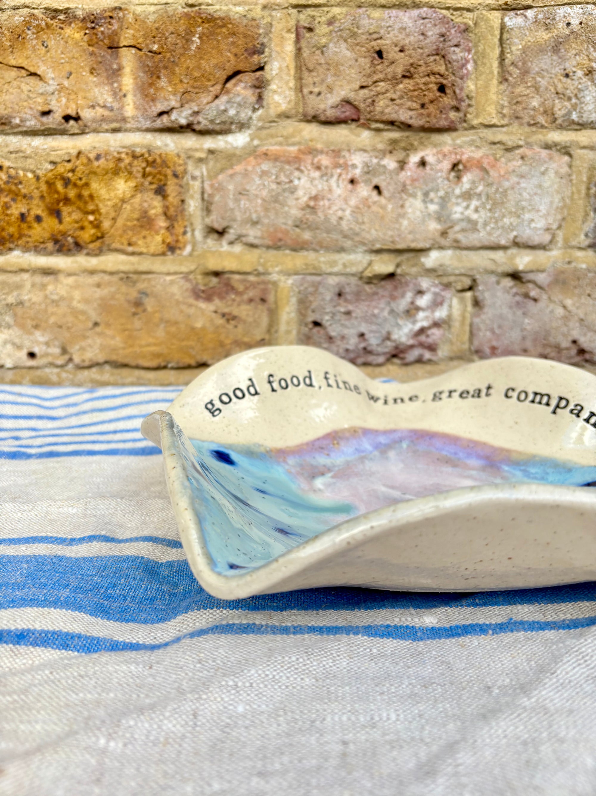 "good food, fine wine, great company..." serving dish