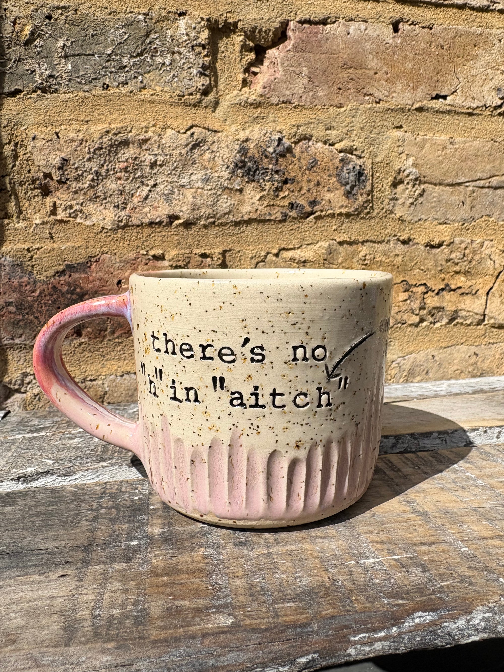 ""there's no "h" in "aitch" except that one" mug (pink)