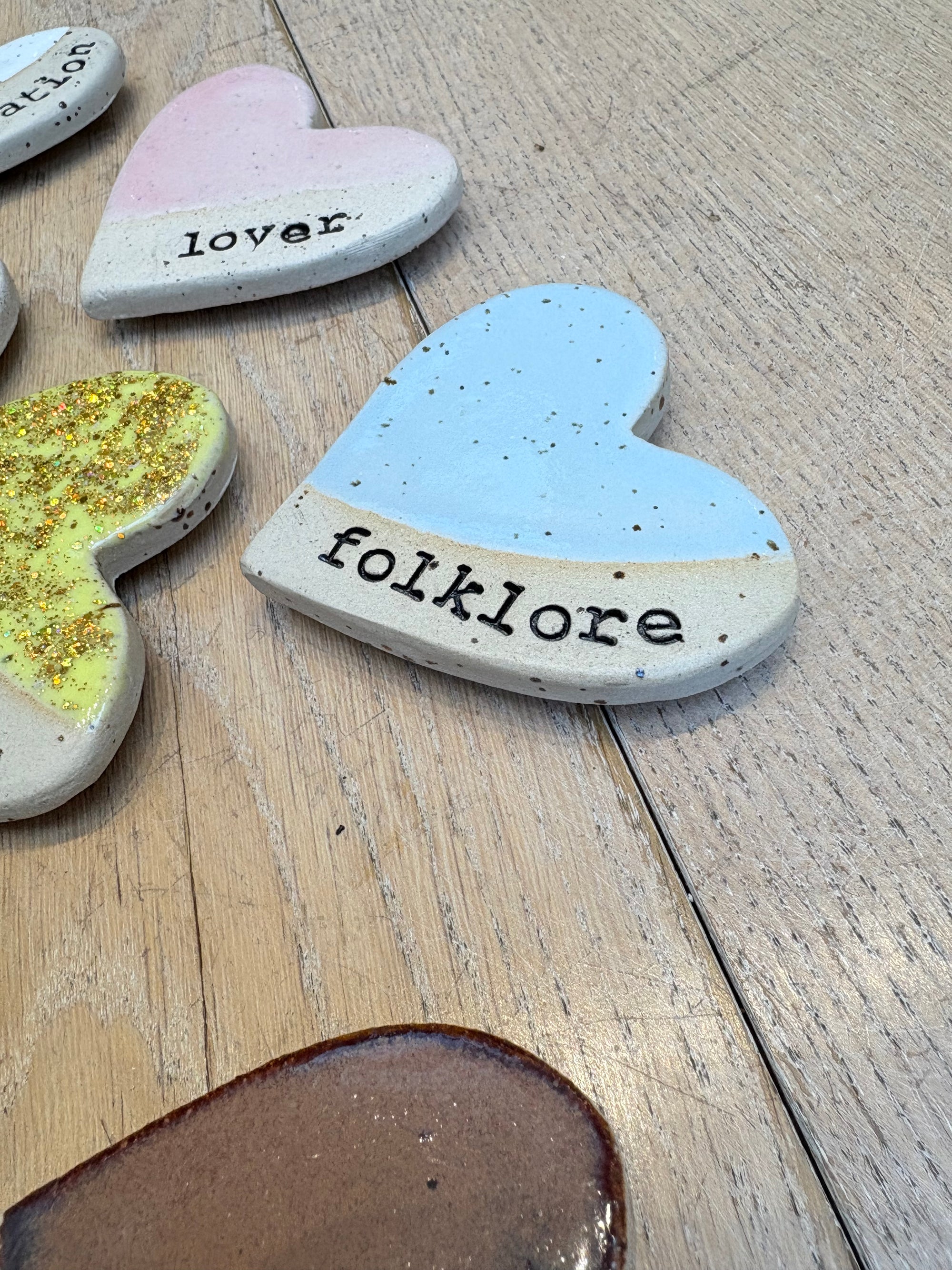 Twelve heart shaped Taylor Swift album magnets