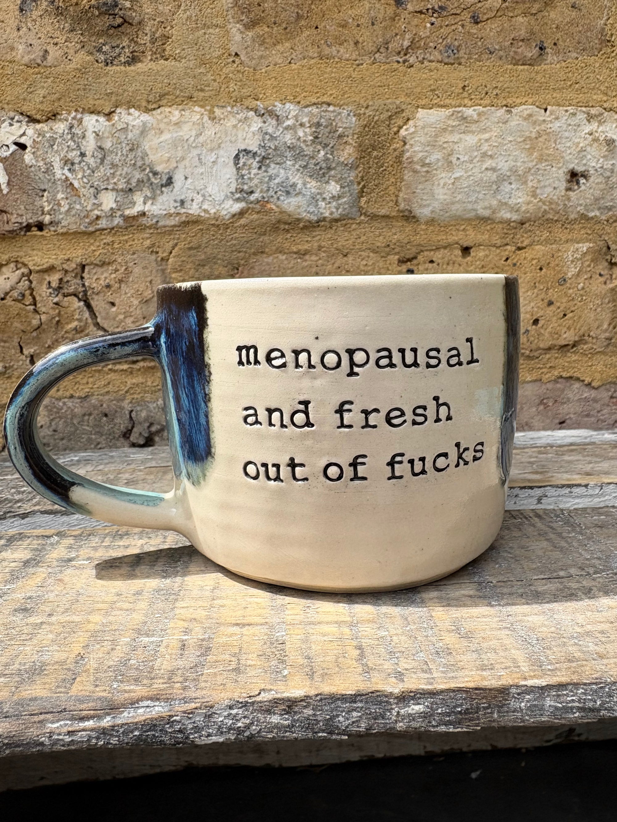 "menopausal and fresh out of fucks" mug (blue shore)
