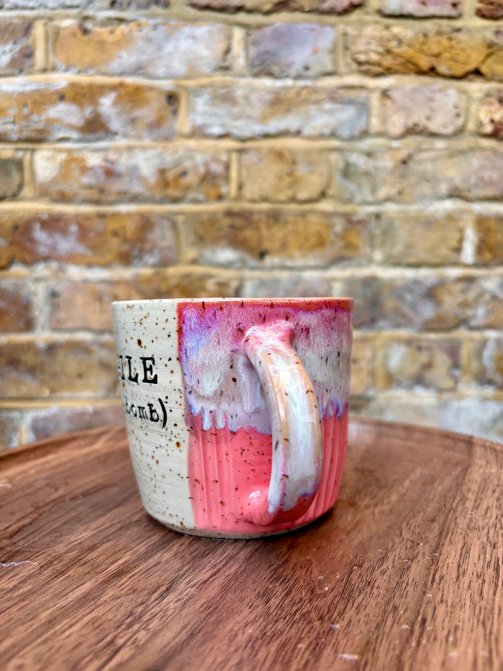 “FRAGILE (like a bomb) mug (pink, black text)