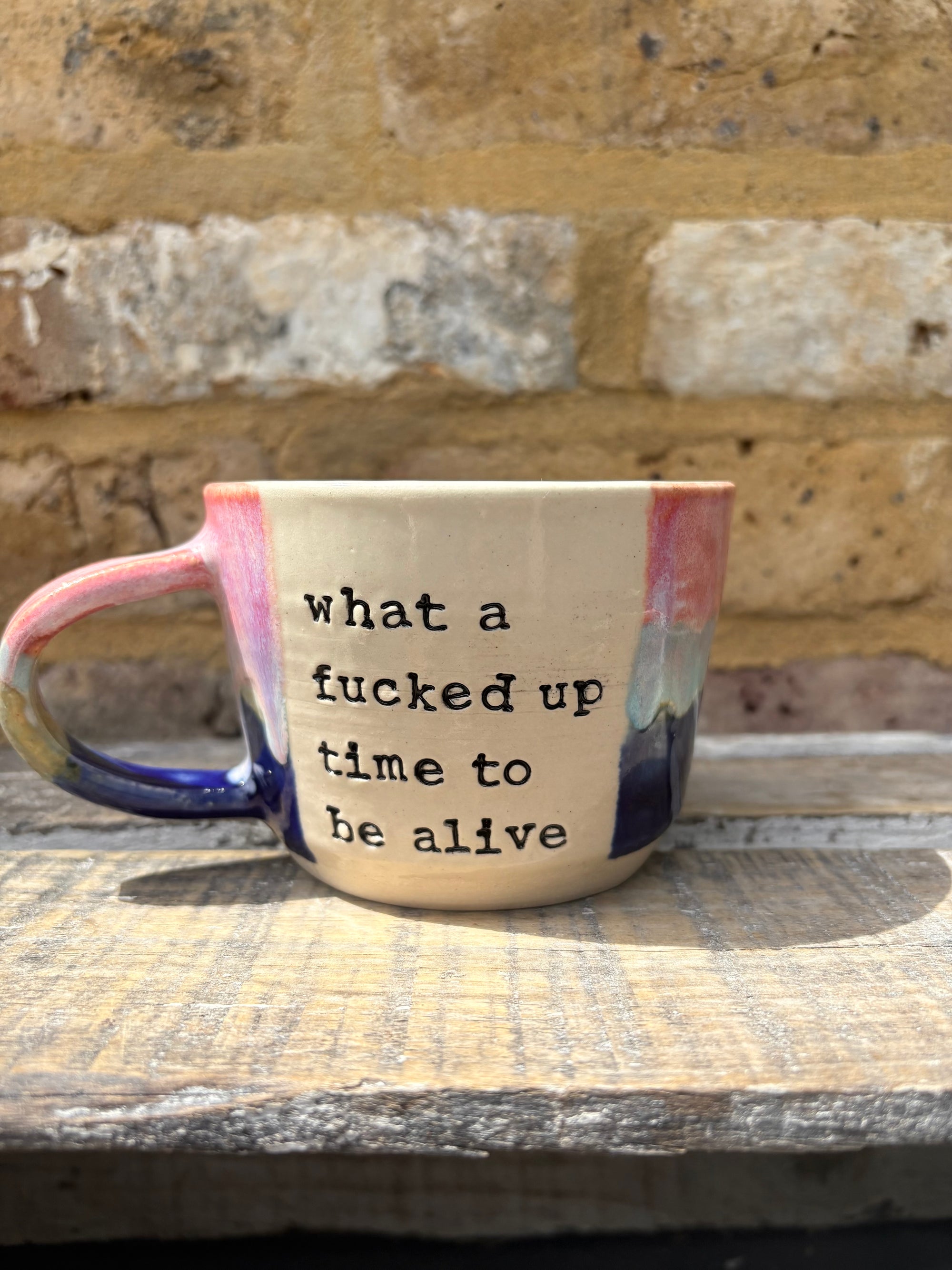 “what a fucked up time to be alive" mug (pink night sky)