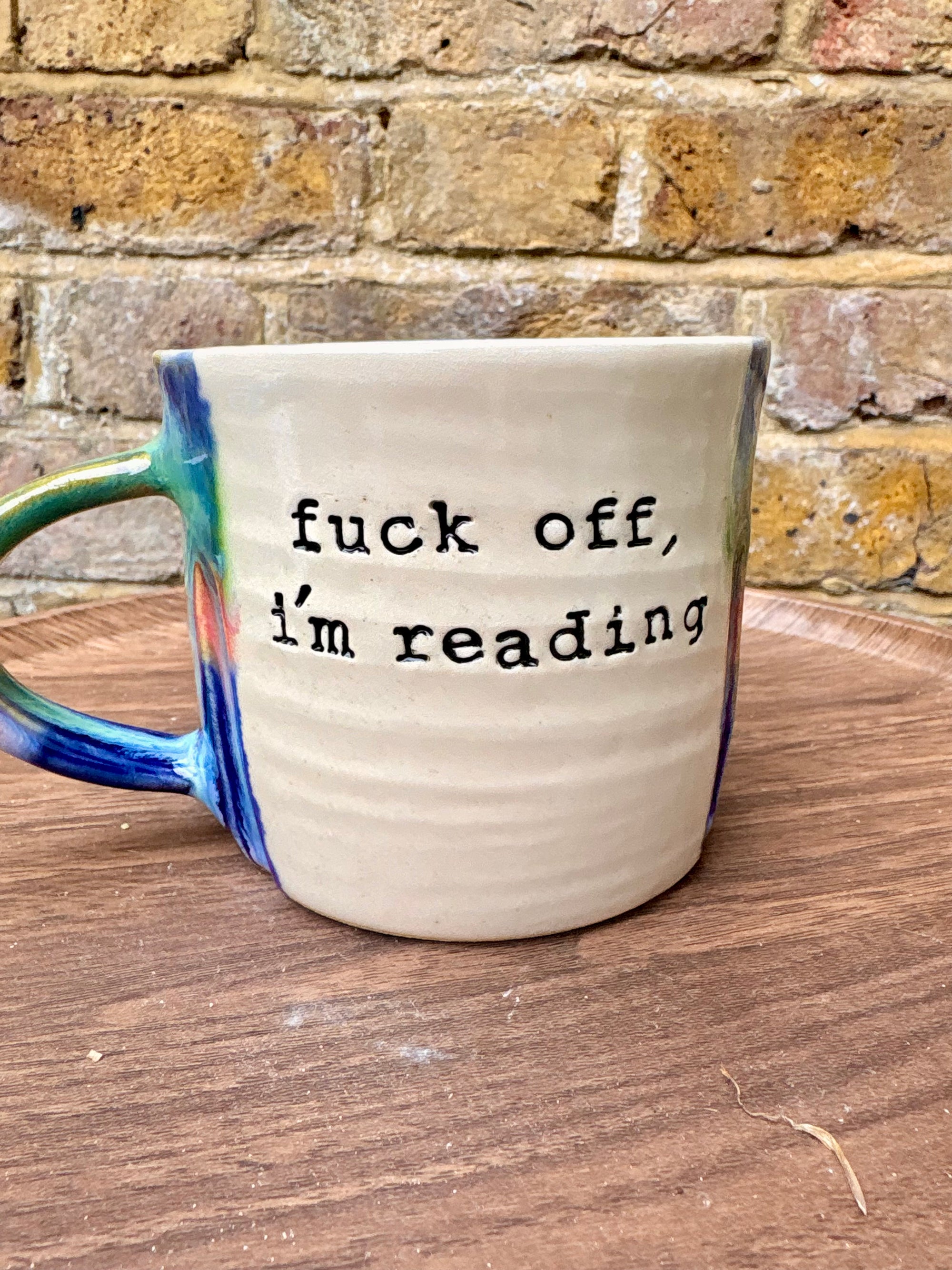 “Fuck off I’m reading" mug (greens/blues)