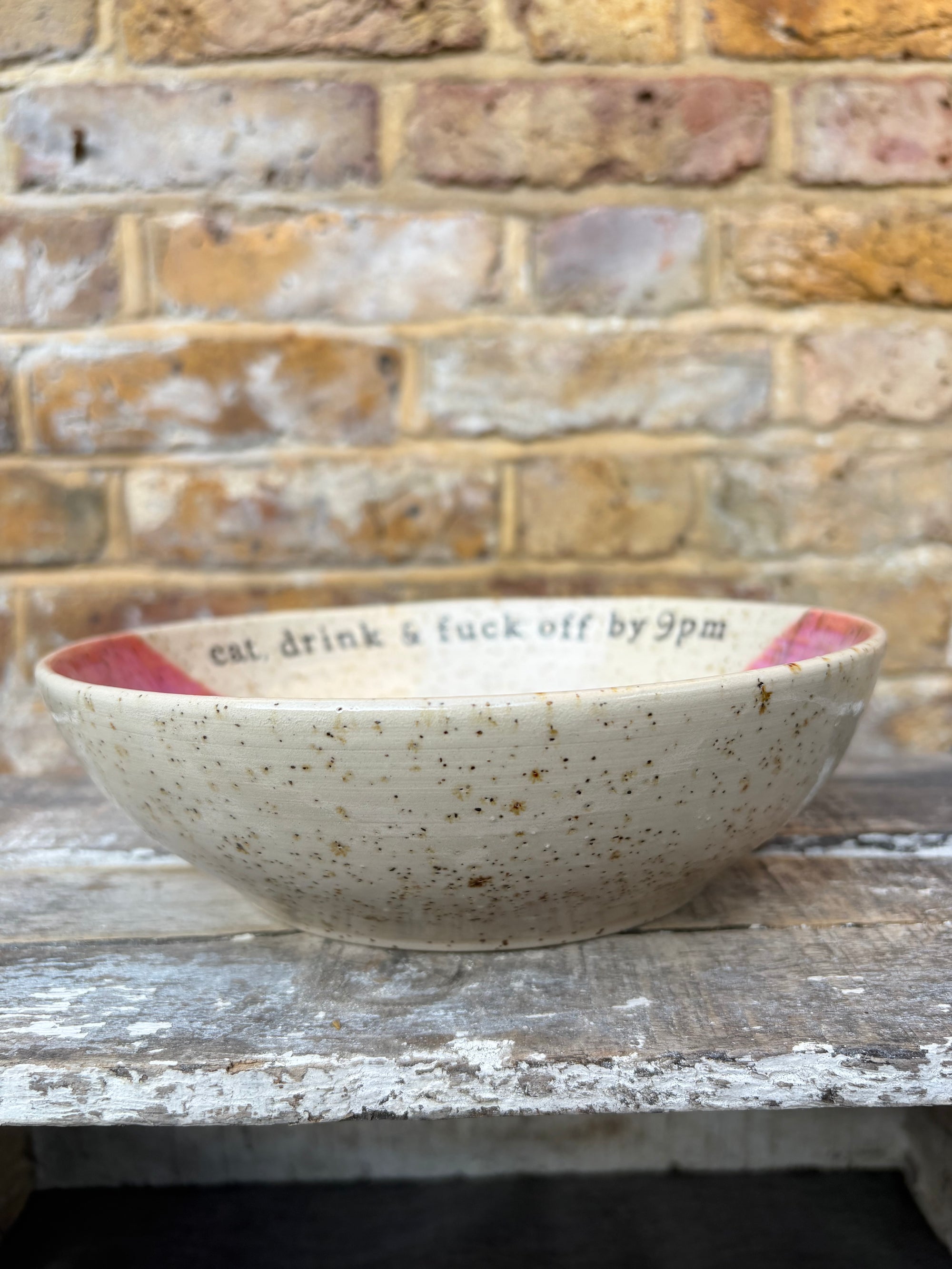 “eat, drink and fuck off by 9pm"  deep round salad/pasta bowl (pink, flecked clay)