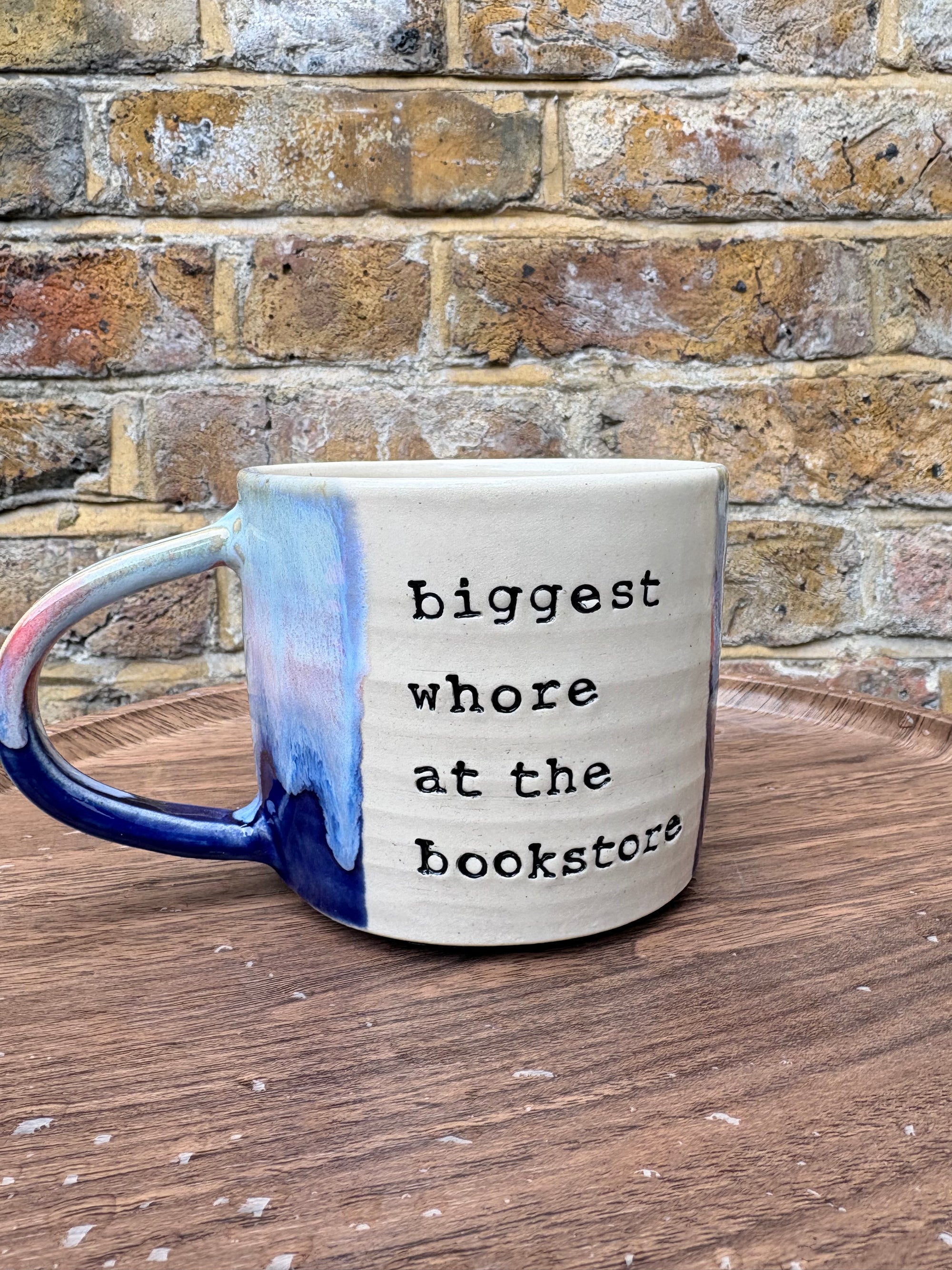 “Biggest whore at the bookstore" mug (Pink/blue/cream)