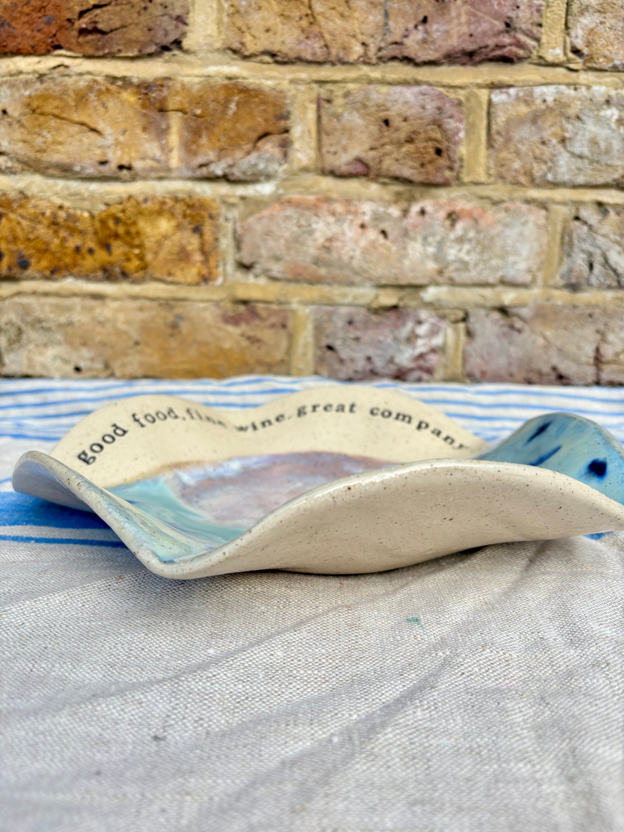 "good food, fine wine, great company..." serving dish