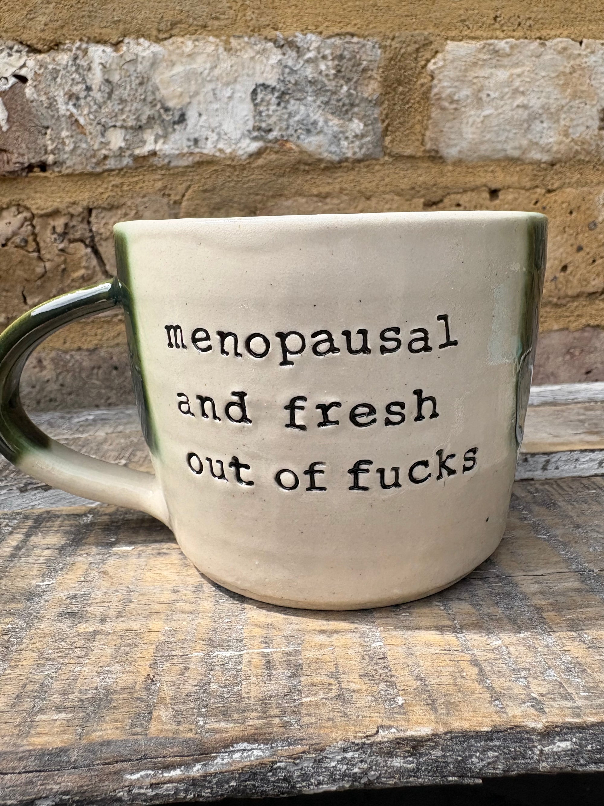 "menopausal and fresh out of fucks" mug (green)