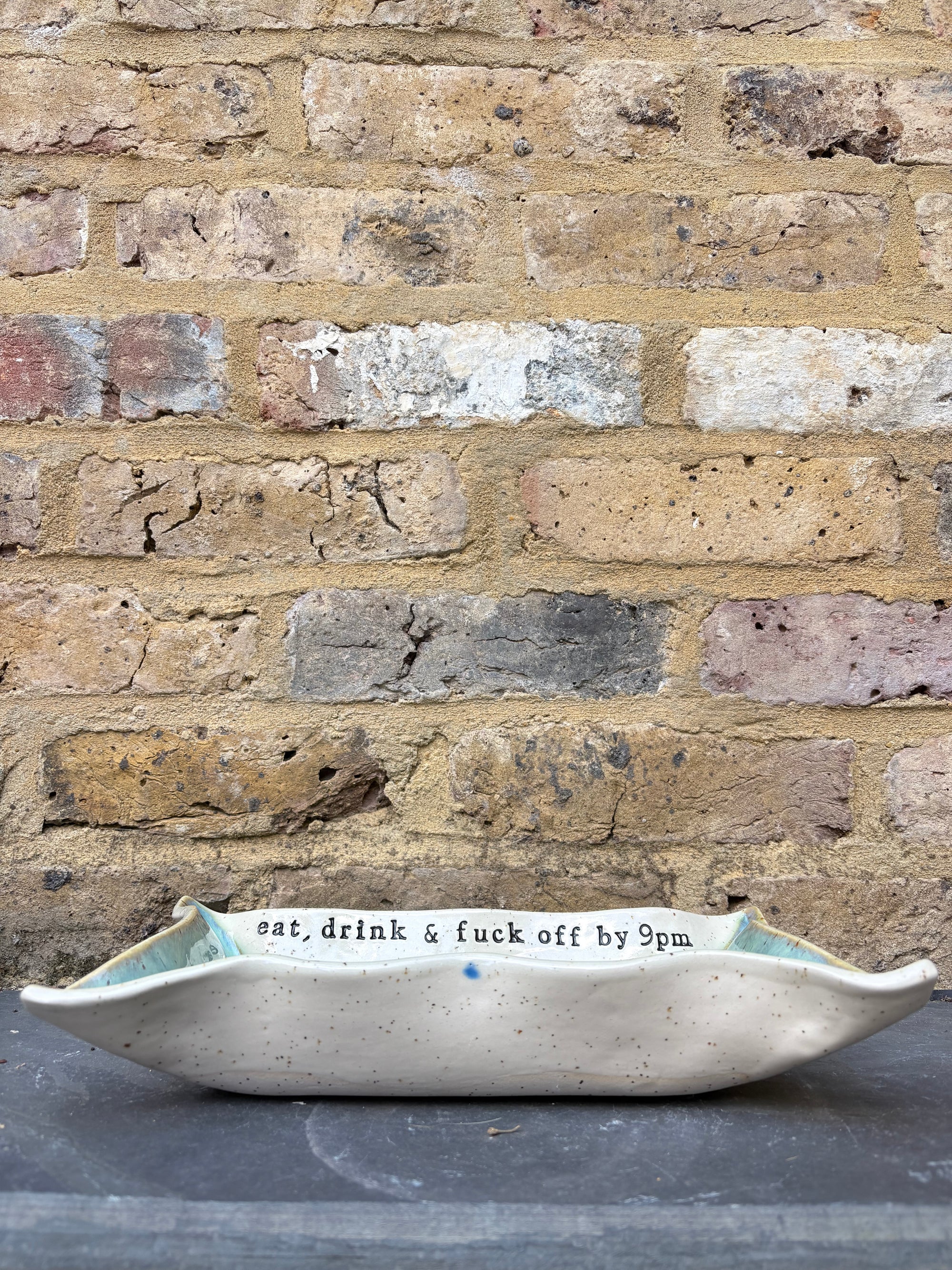 “eat, drink and fuck off by 9pm" rectangular dish (green, flecked clay)