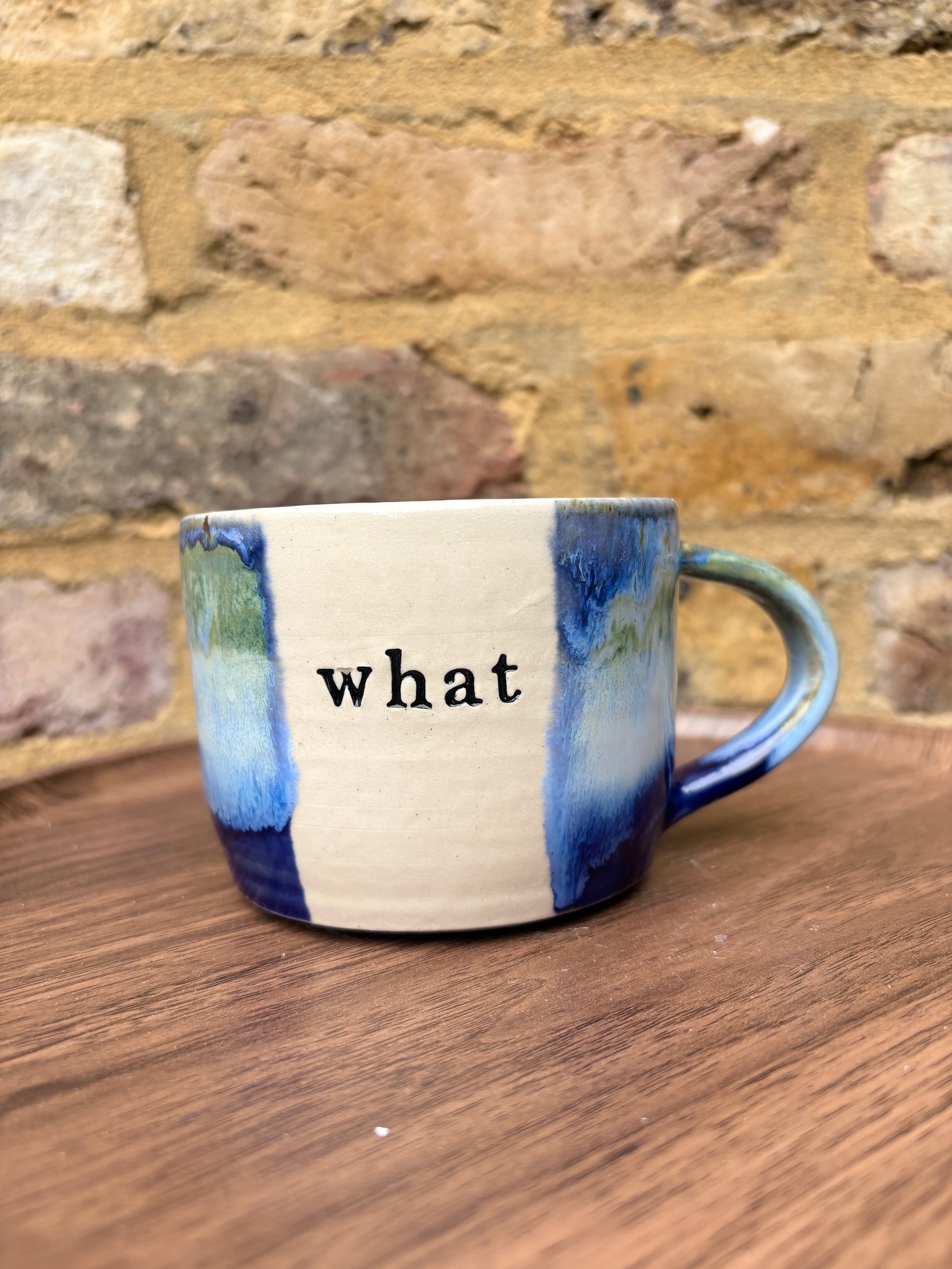 “What” “the fuck” mug (cream, blue/green)