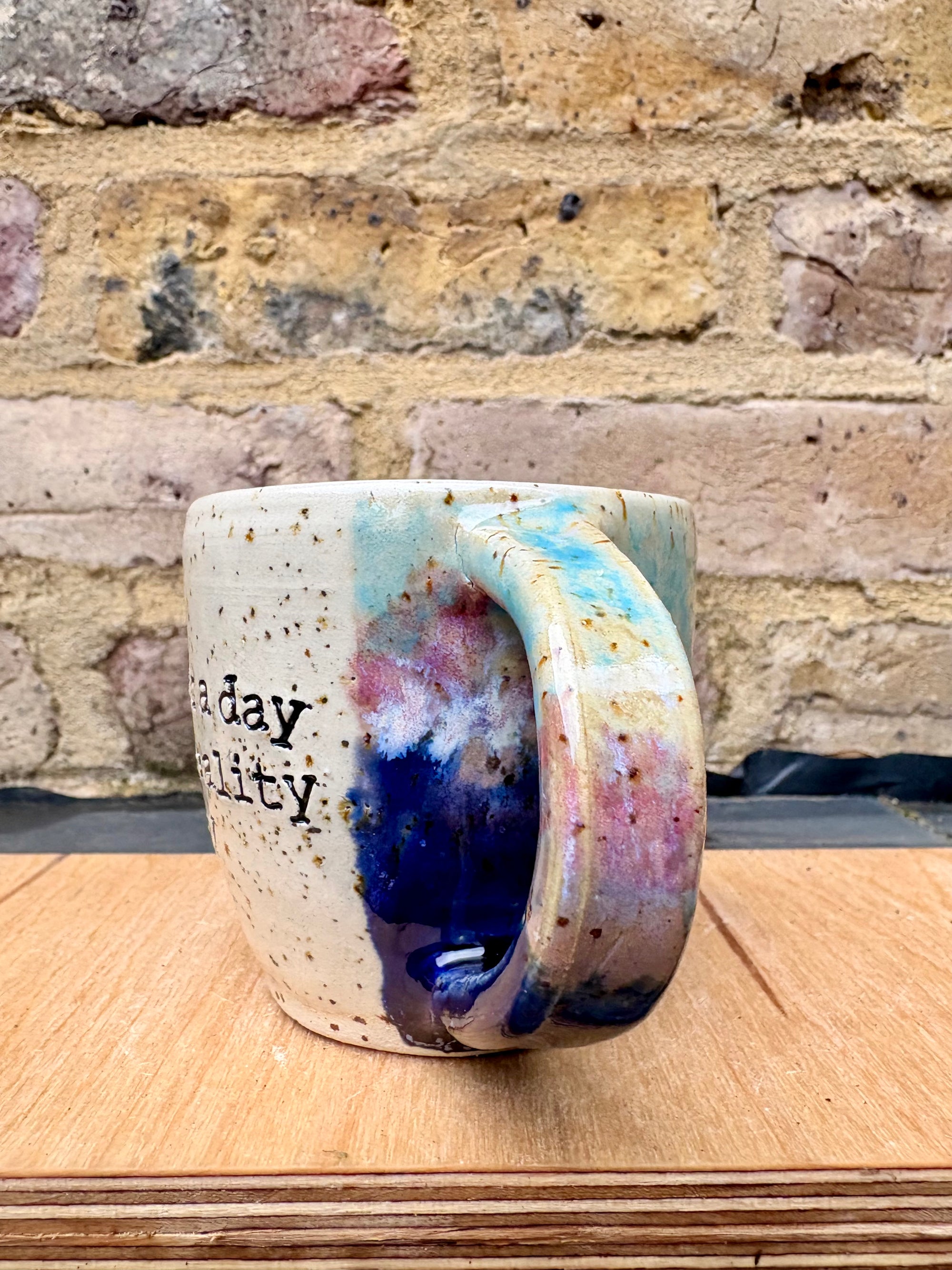 “A book a day keeps reality away" mug (blue night sky)
