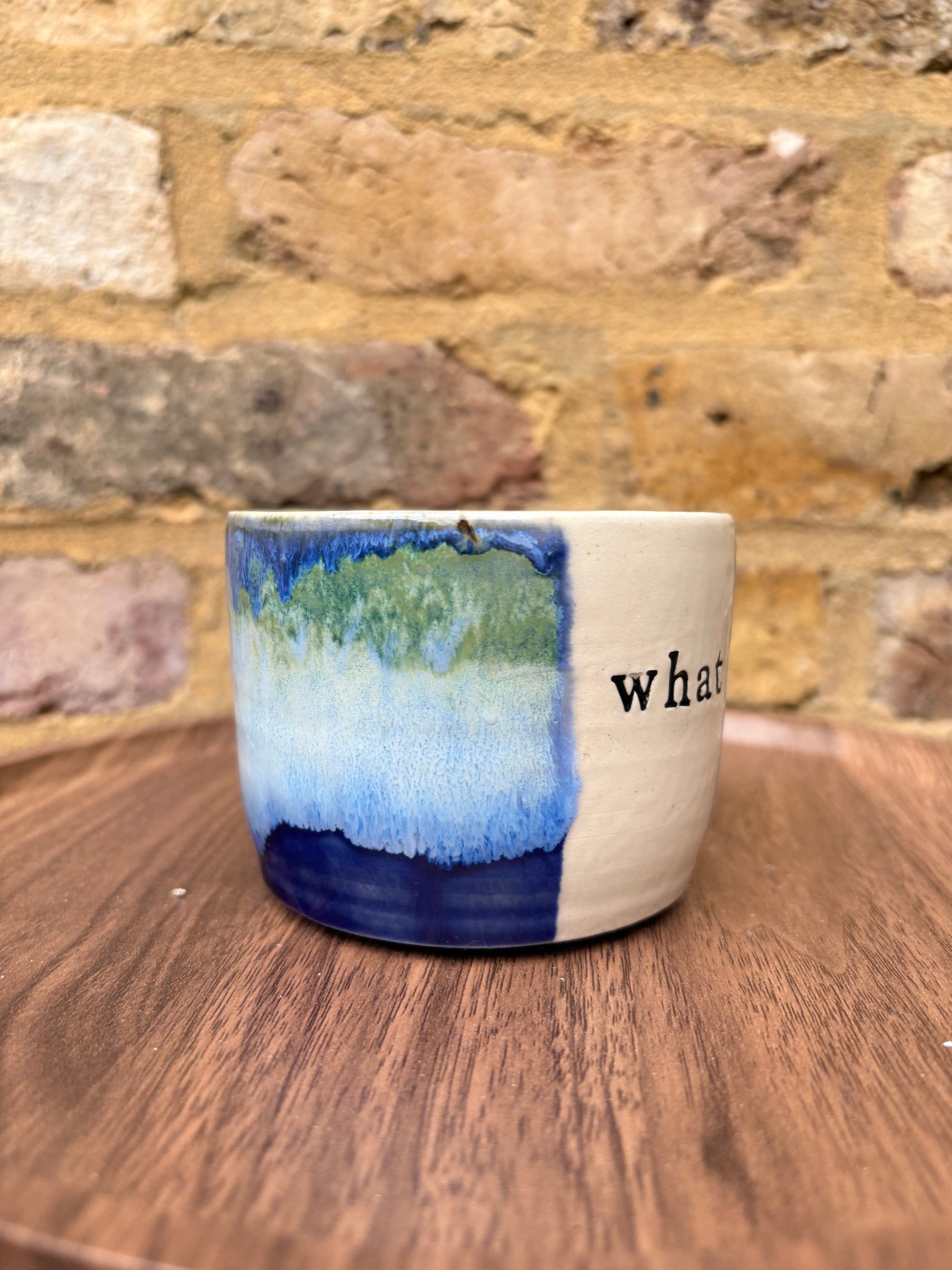 “What” “the fuck” mug (cream, blue/green)