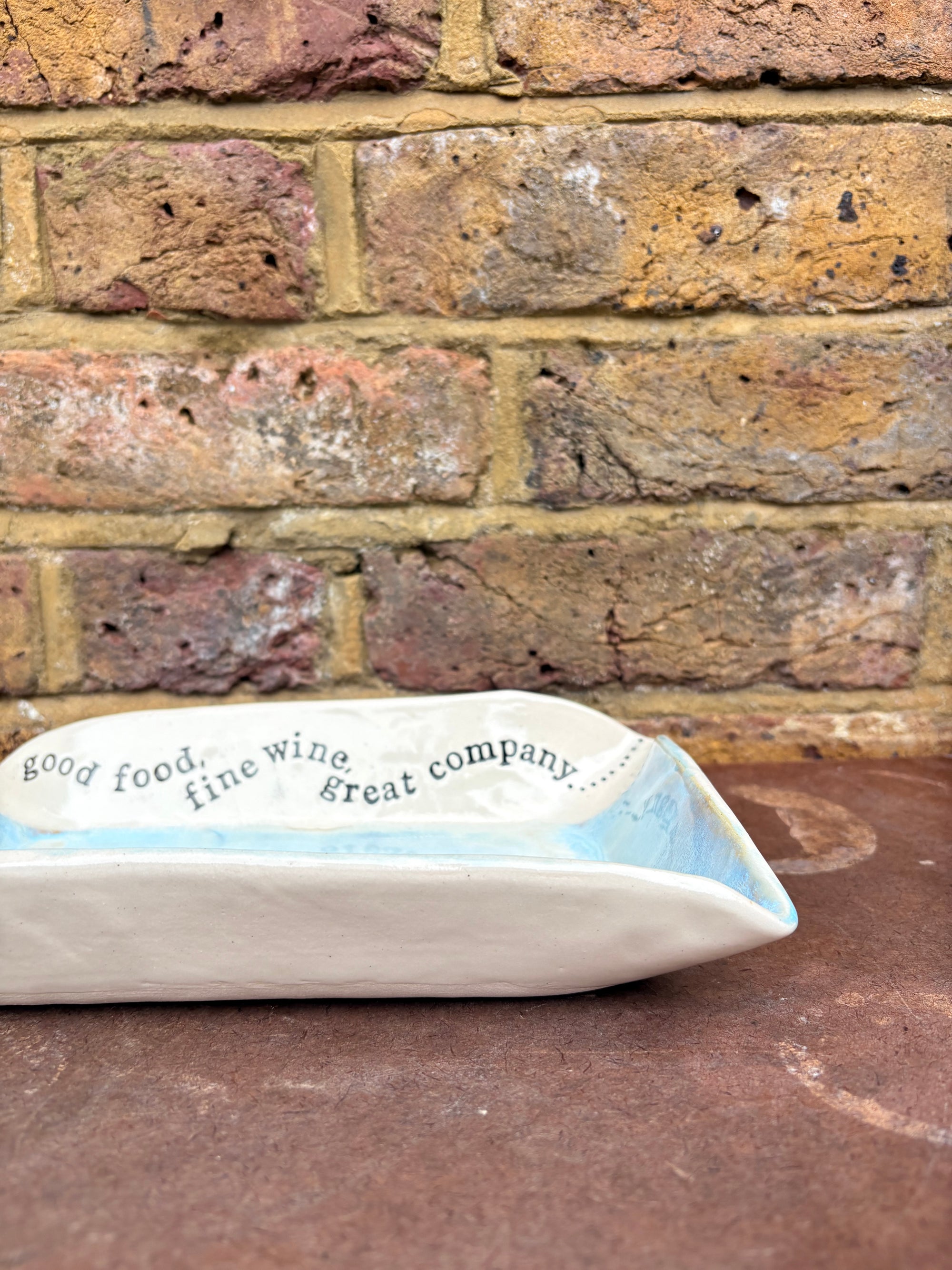 “good food, fine wine, great company..." rectangular salad/serving dish