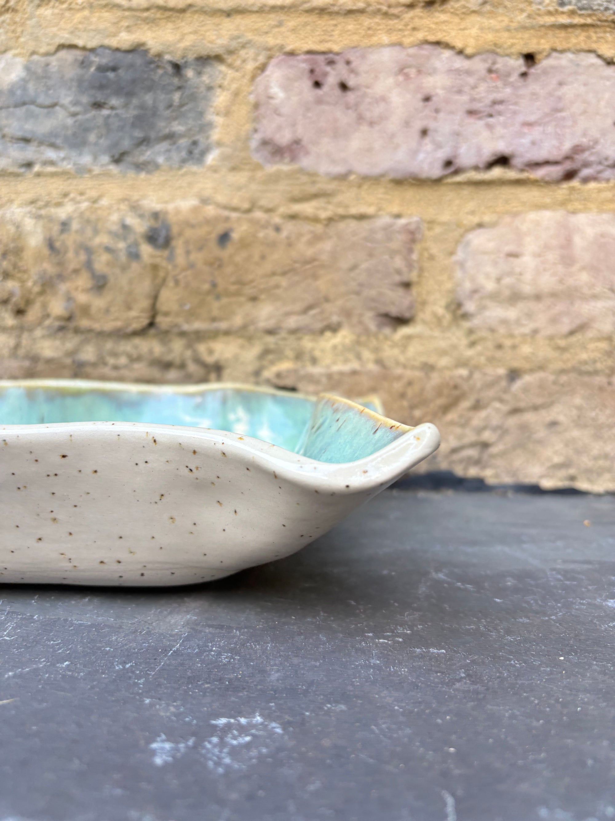 “eat, drink and fuck off by 9pm" rectangular dish (green, flecked clay)