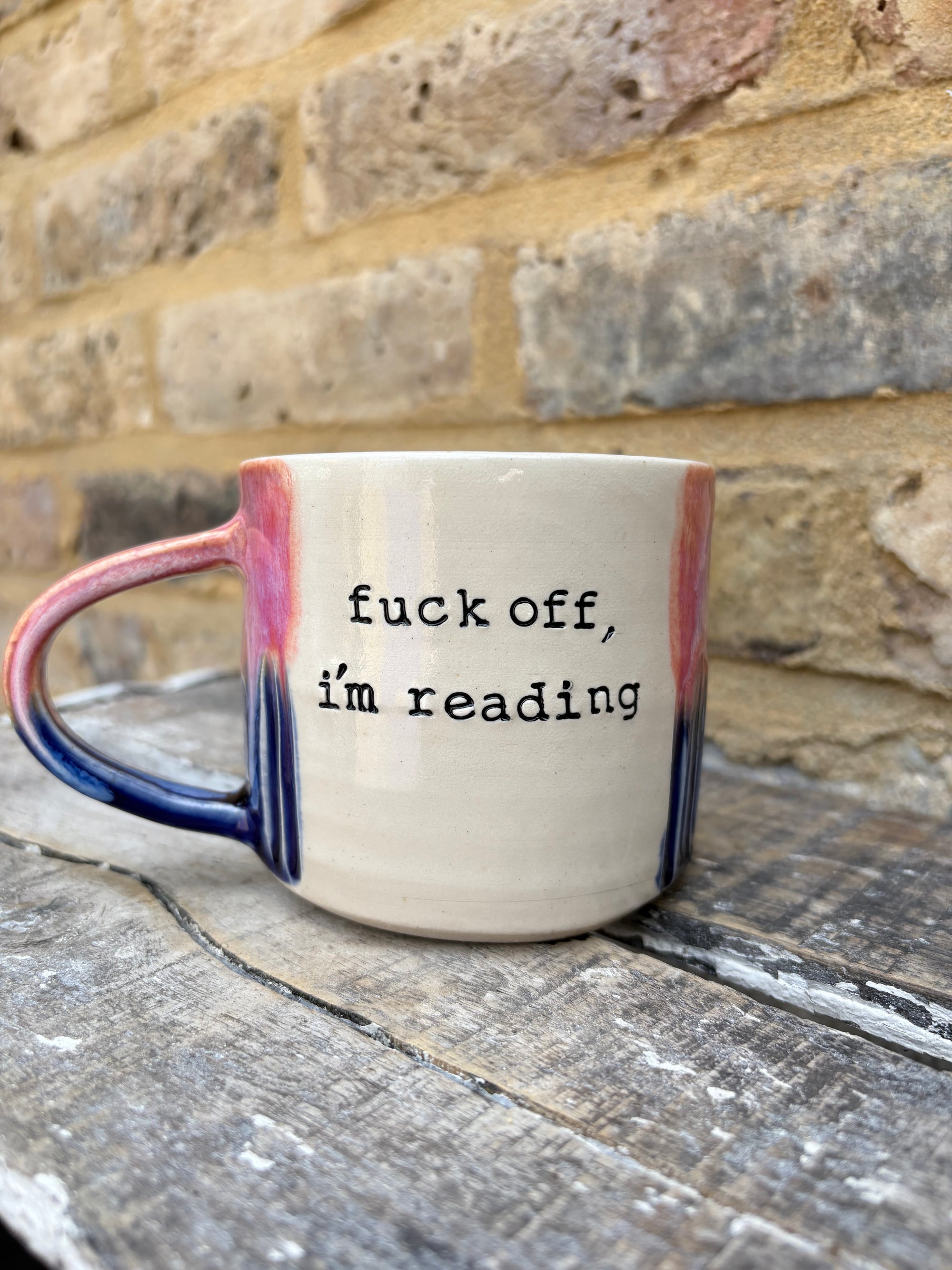 Two “fuck off i’m reading” mugs