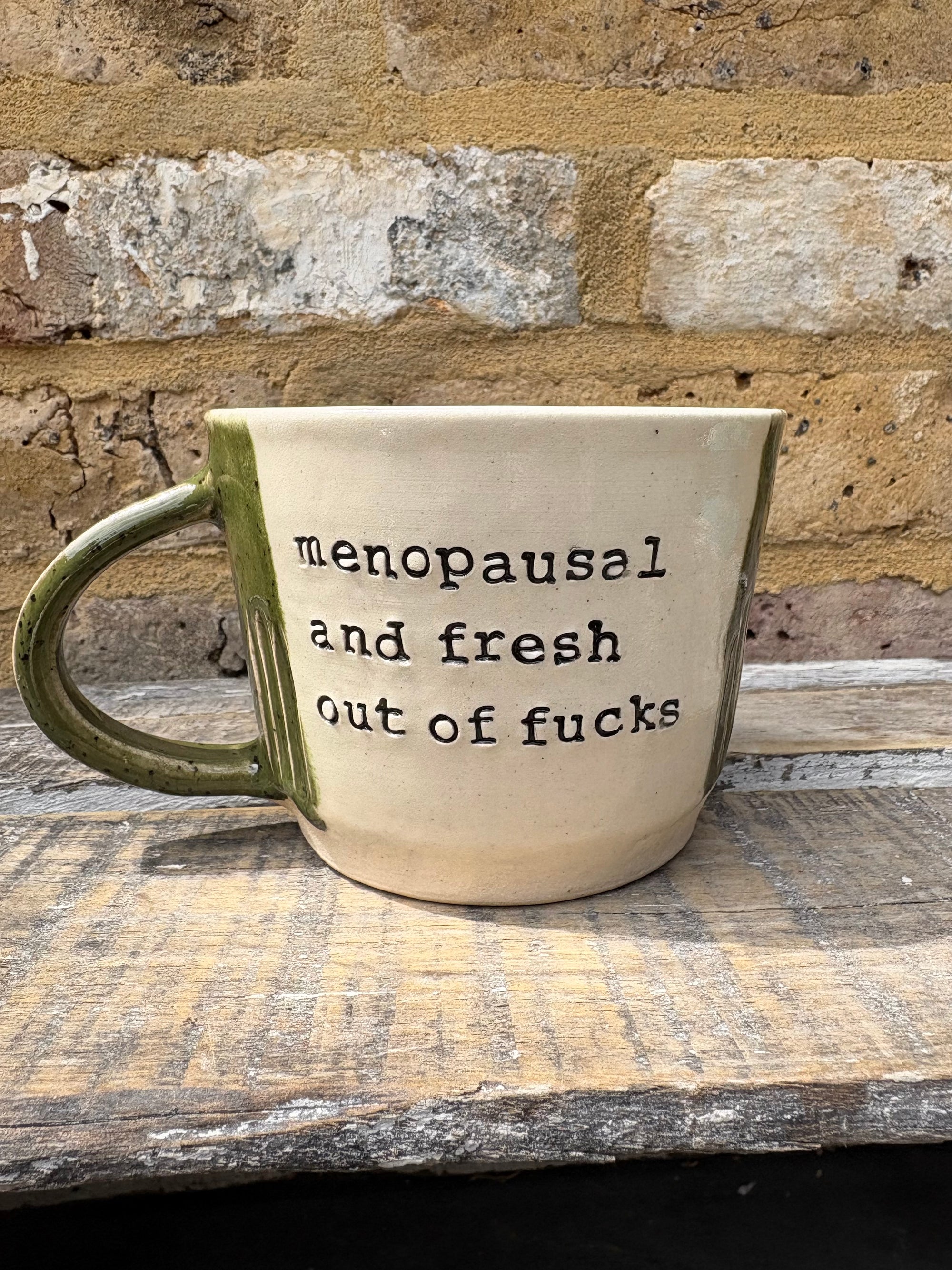 "menopausal and fresh out of fucks" mug (speckled green)