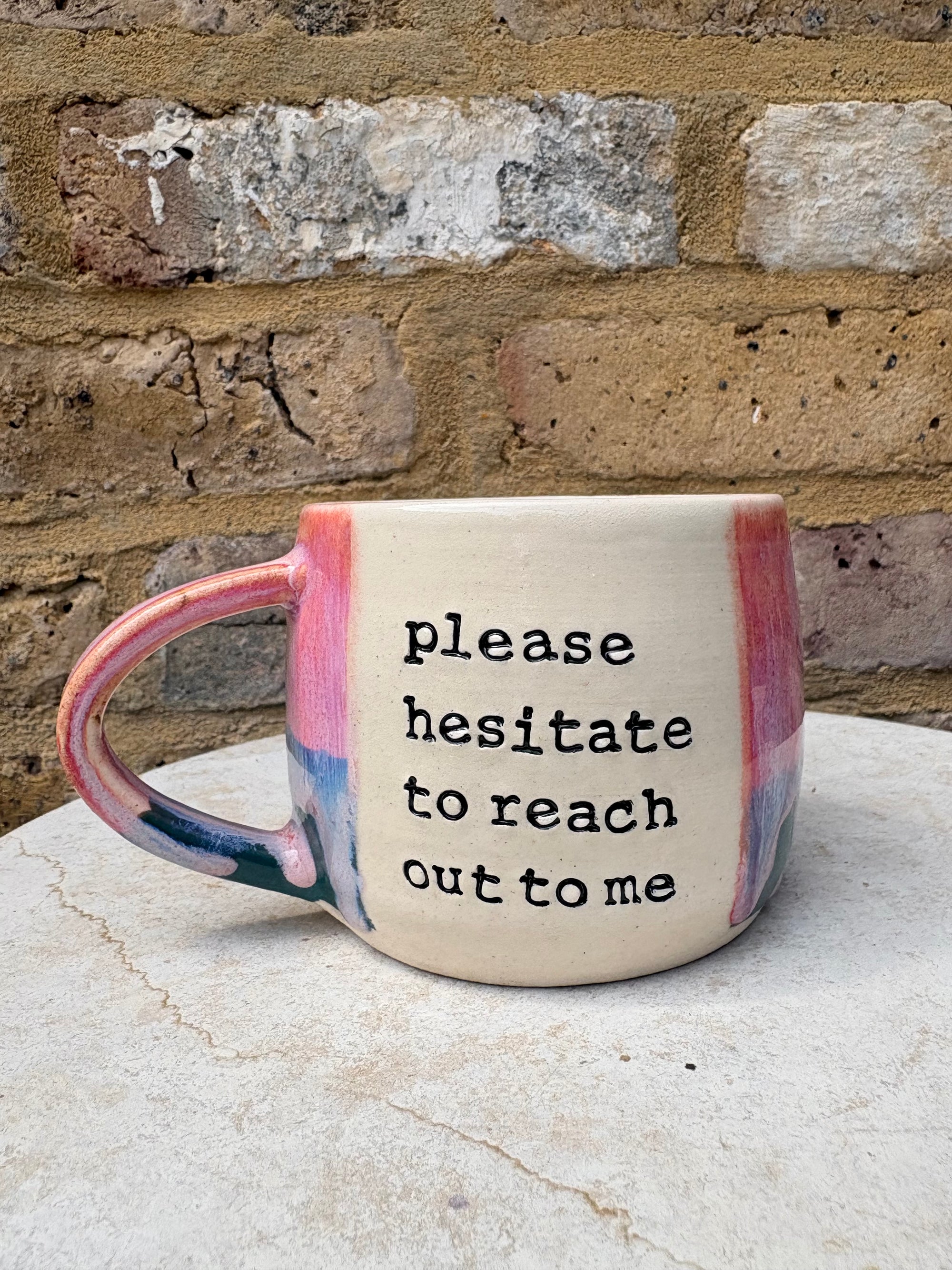 "please hesitate to reach out to me" mug (pink/green)