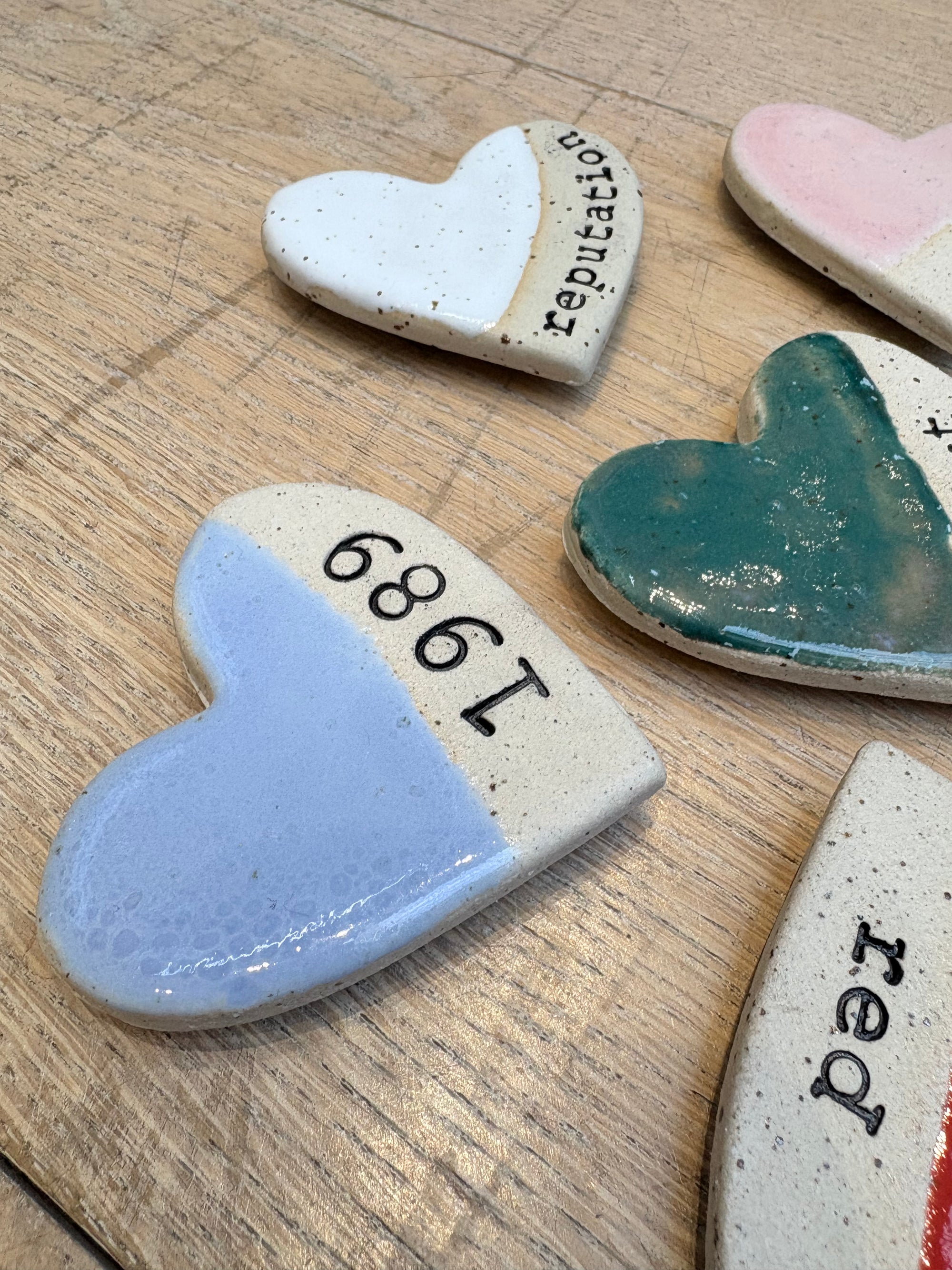Twelve heart shaped Taylor Swift album magnets
