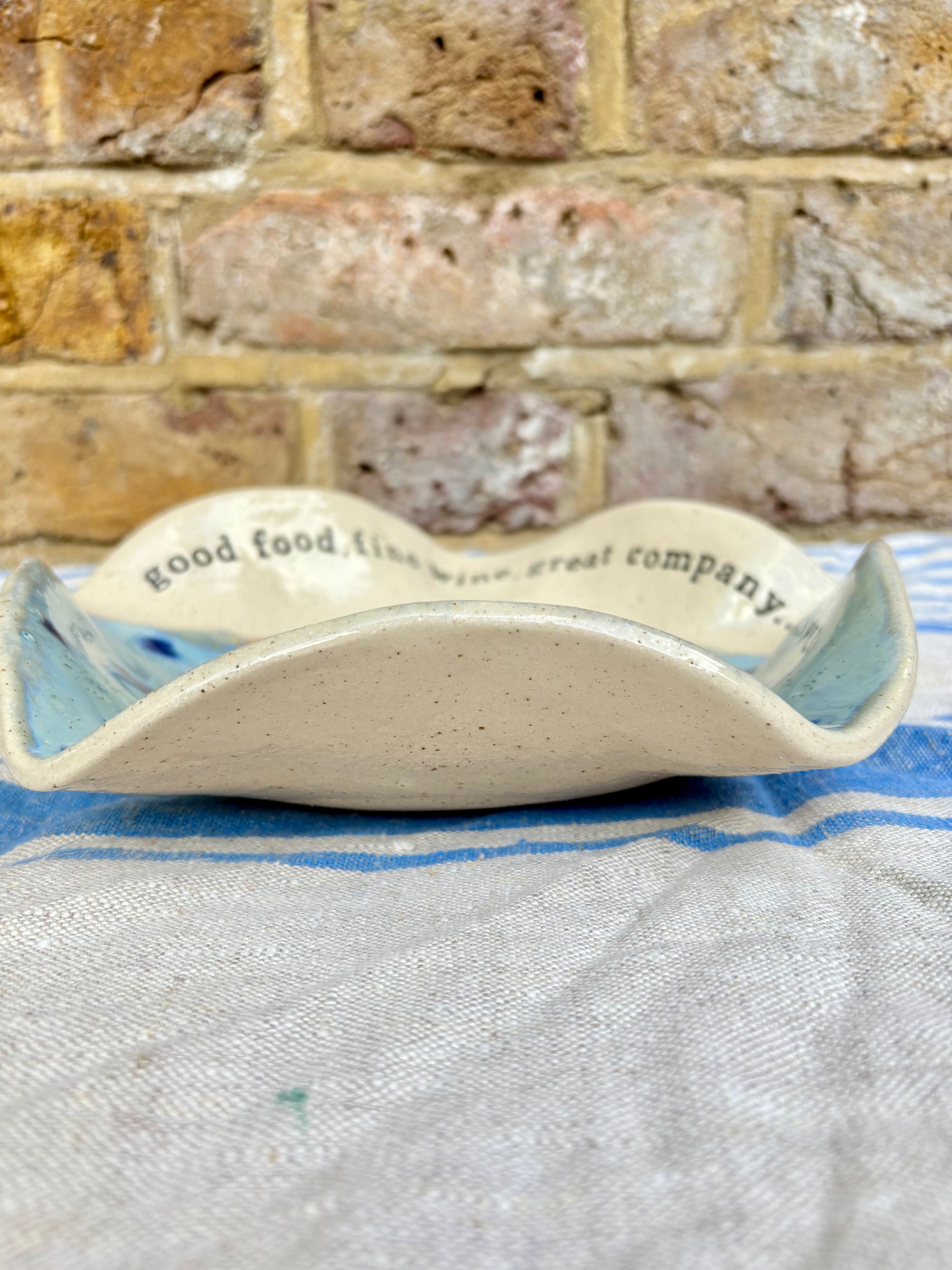 "good food, fine wine, great company..." serving dish